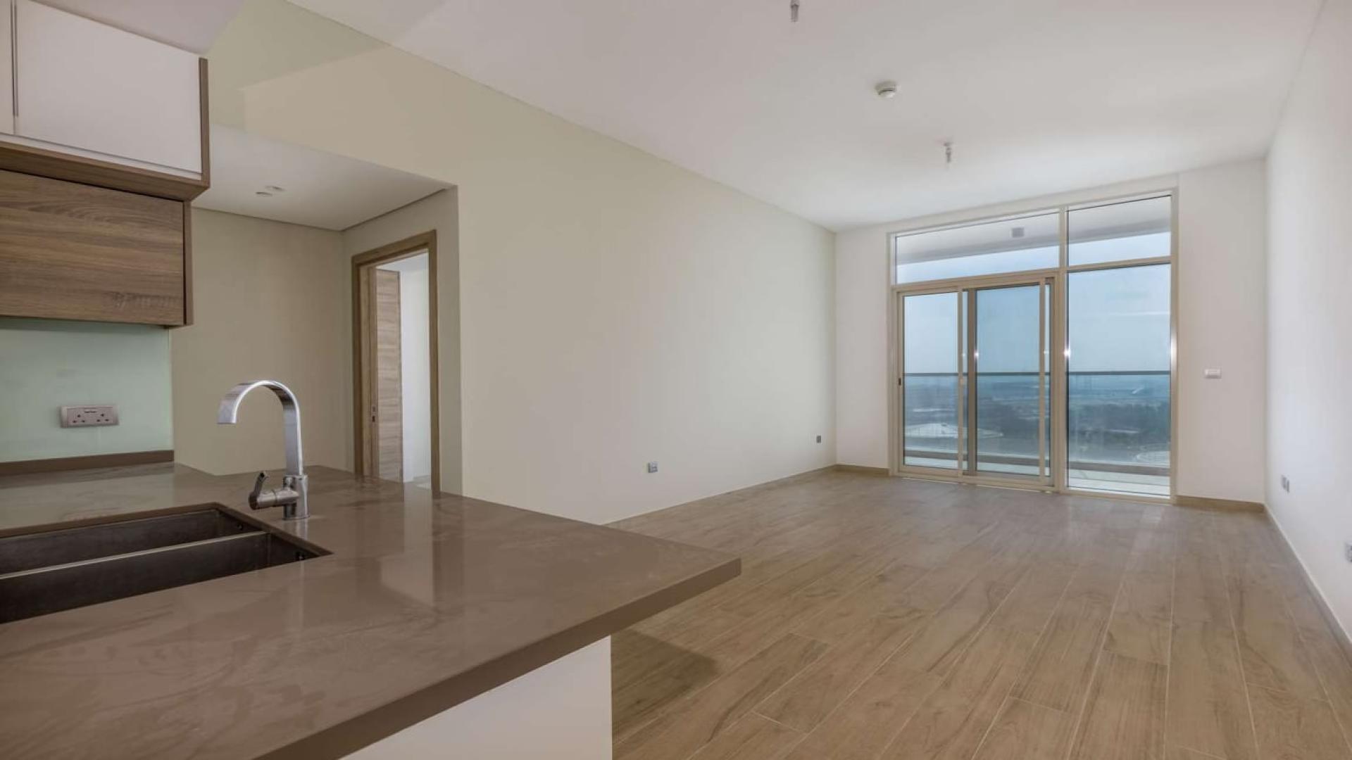 Modern kitchen and living area in Dubai Marina apartment with balcony sea view