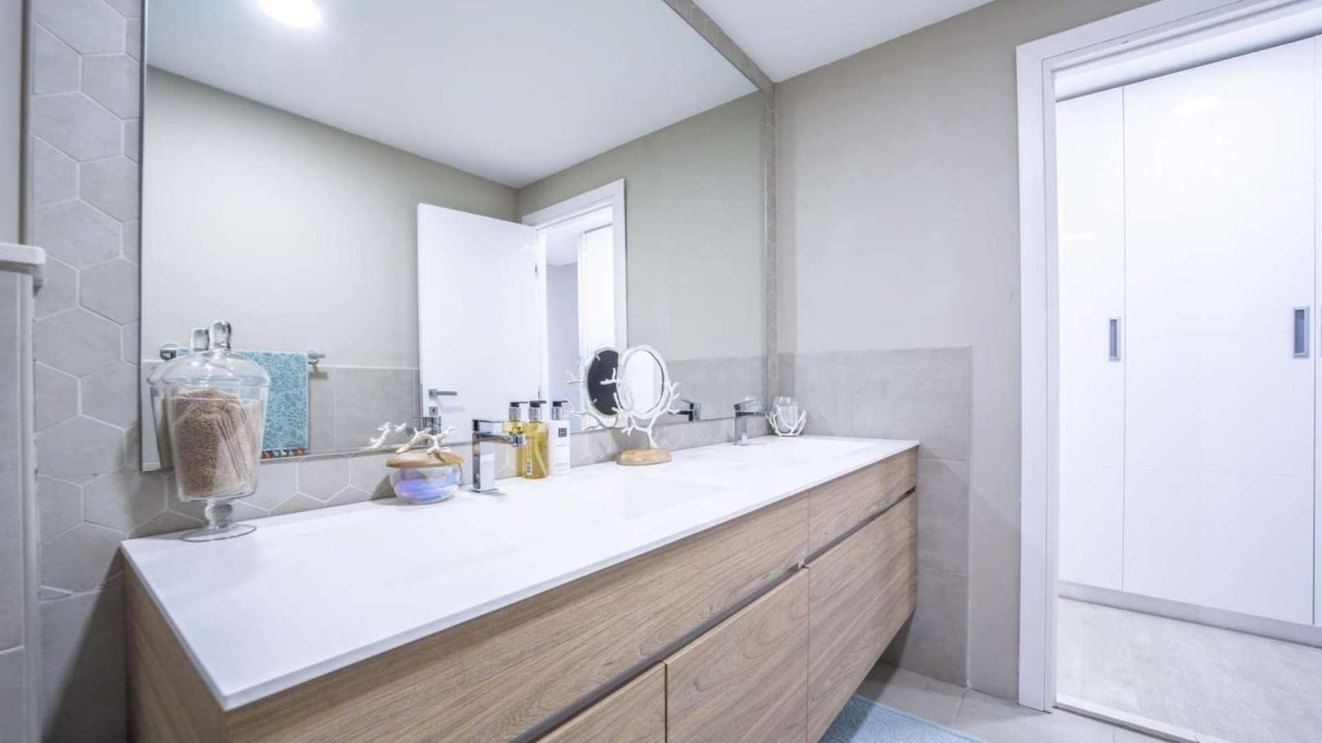 Modern living room with open kitchen in Jumeirah Golf Estates apartment, Al Andalus