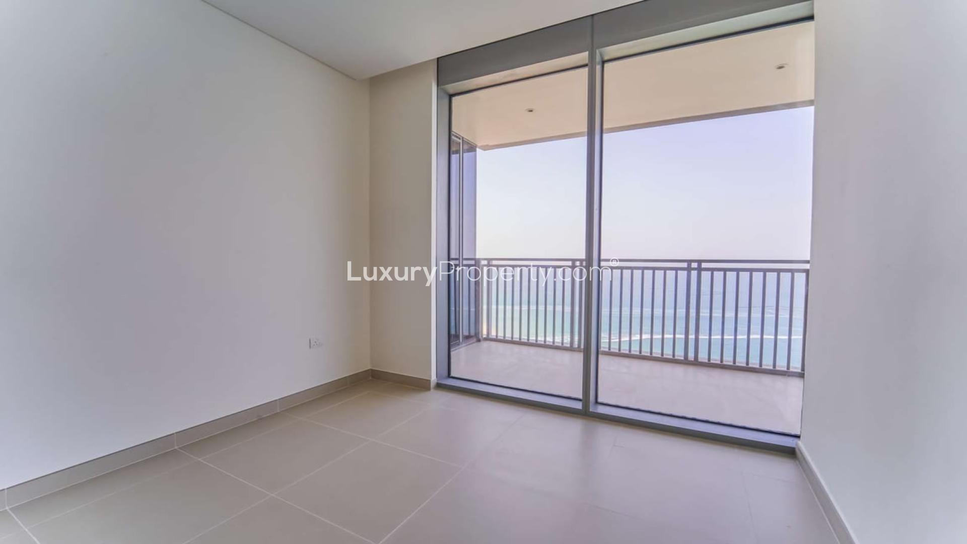 Modern kitchen in high-floor Dubai Marina apartment, featuring sleek wooden cabinets and ample lighting