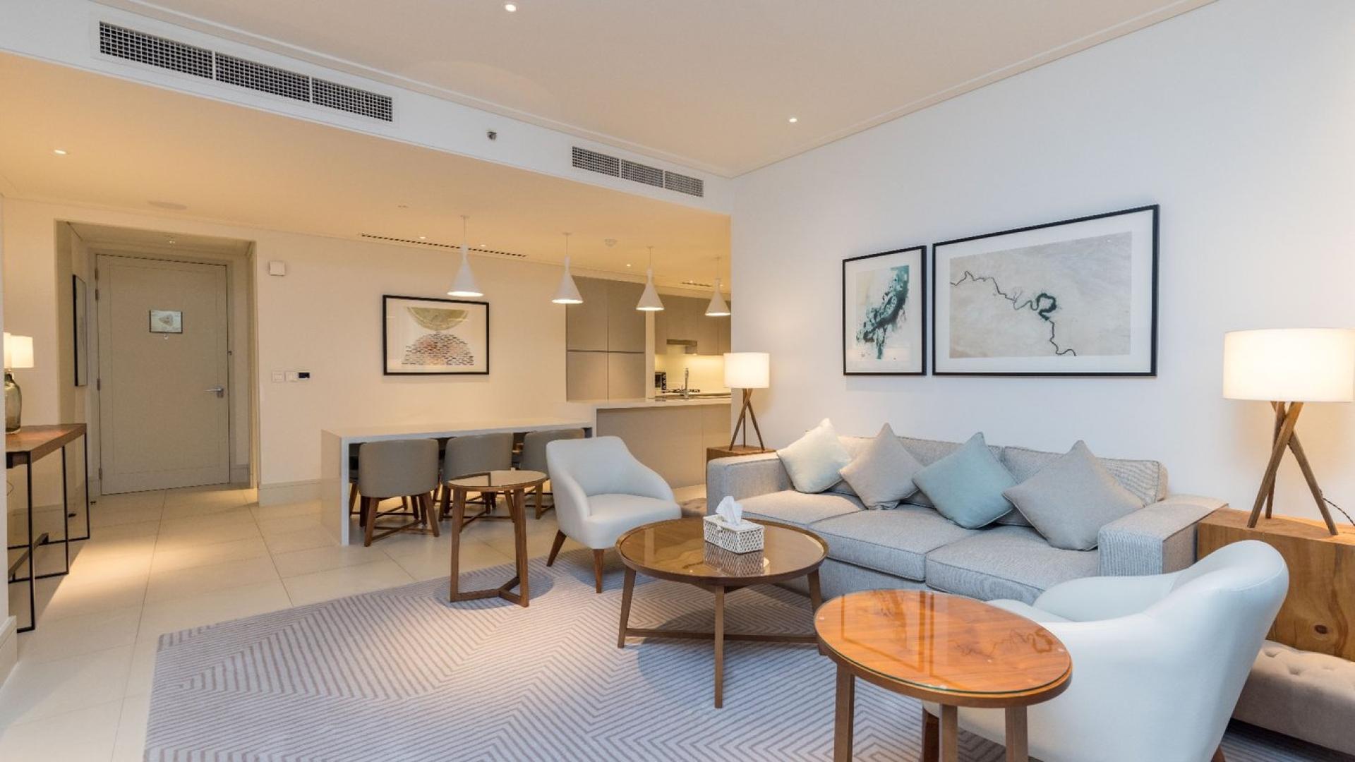 Luxurious furnished apartment living area and kitchen in Vida Residence Downtown Dubai