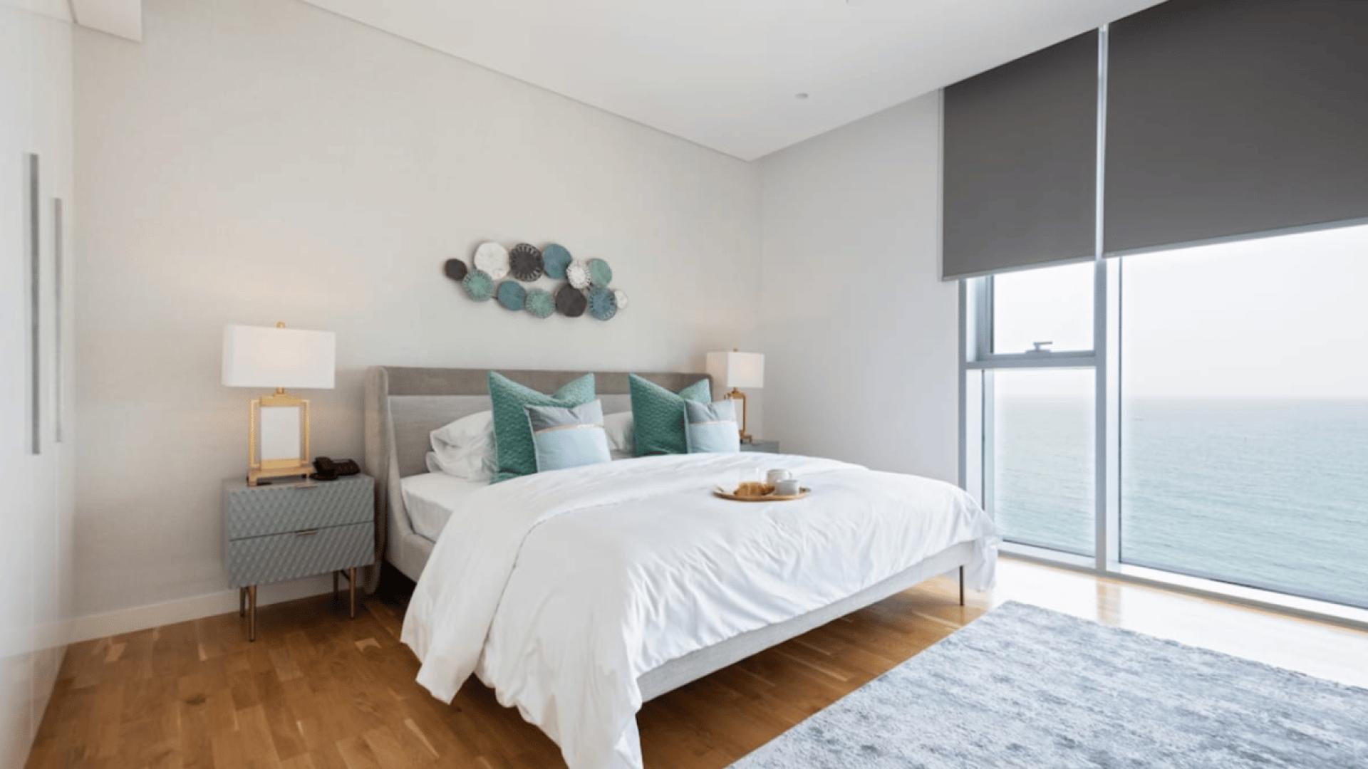 Stylish living room in Bluewaters two-bedroom apartment with modern decor and large TV