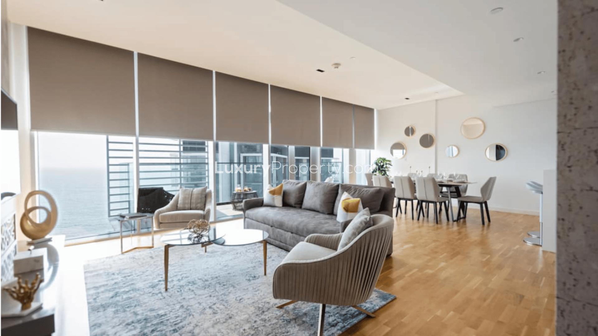 Modern living and dining area in two-bedroom Bluewaters apartment with ocean view