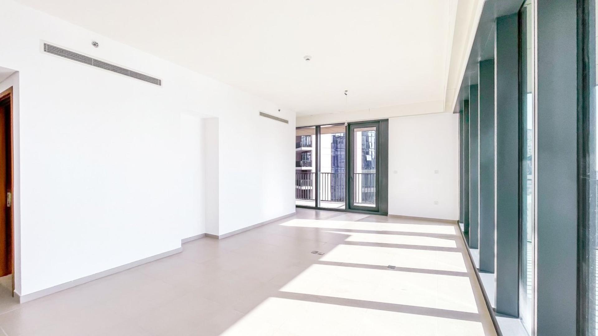 Bright living room with floor-to-ceiling windows, stunning Downtown Dubai skyline view, BLVD Heights