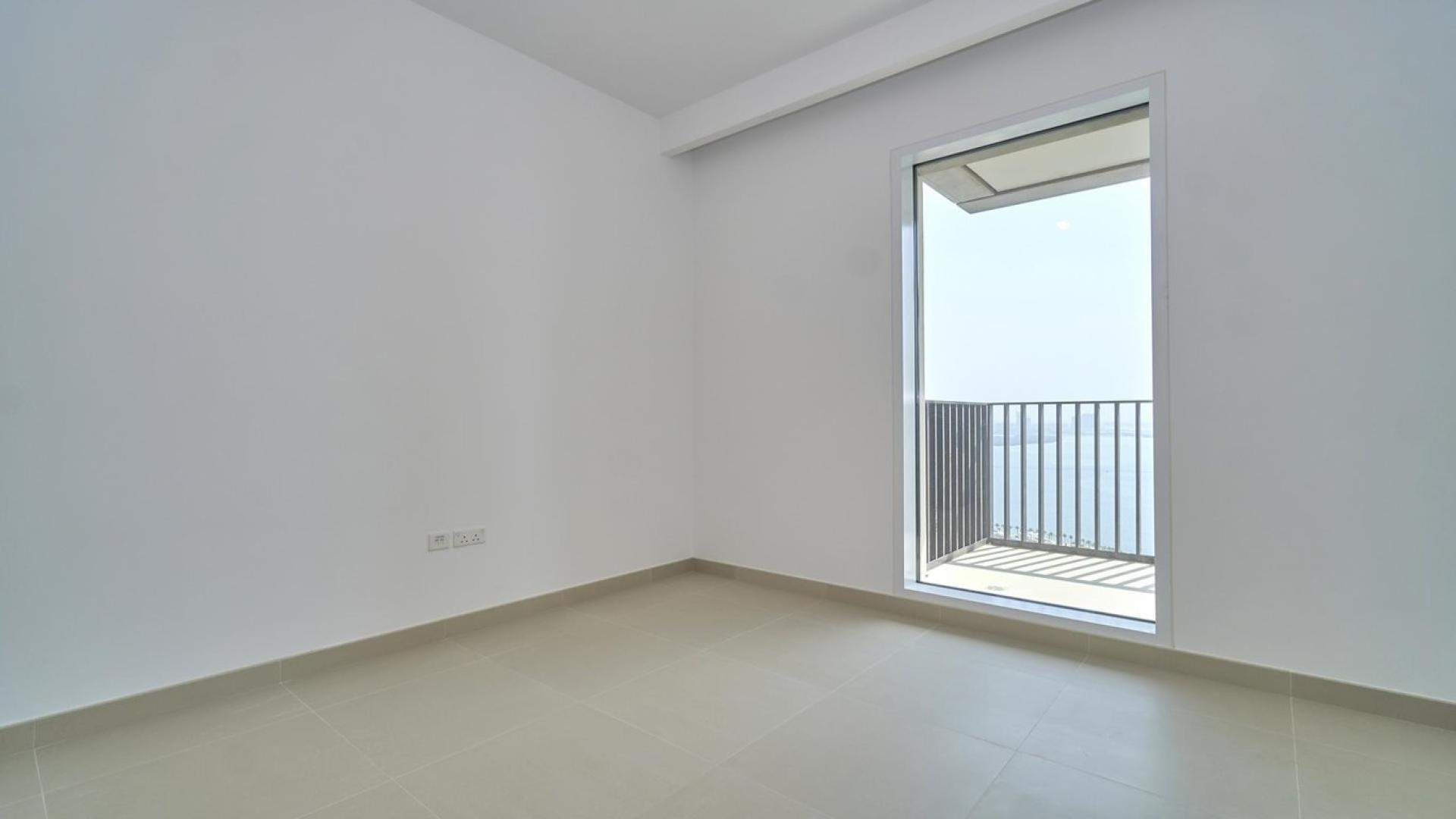 Spacious open-plan living area in Dubai Creek Harbour apartment, featuring modern kitchen design