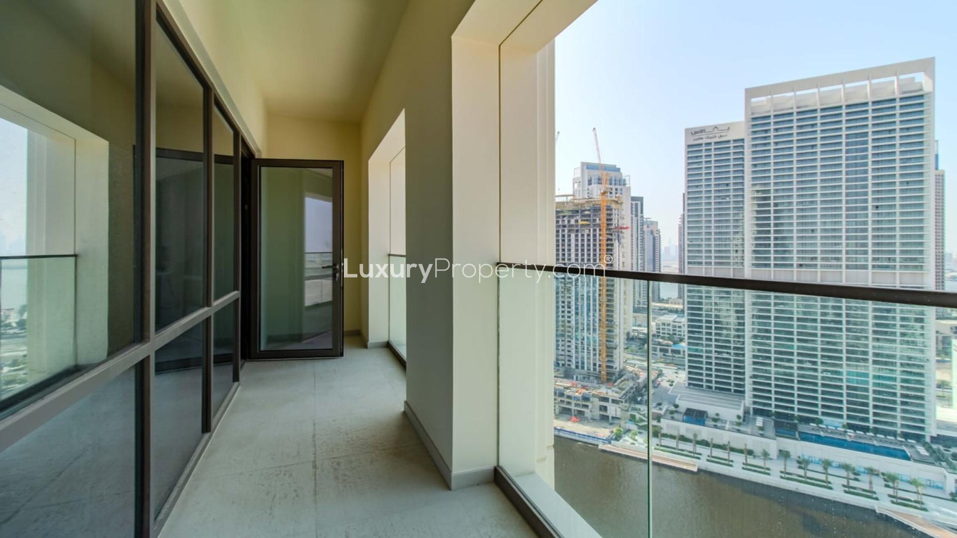 "Spacious living room with canal view, luxury apartment, Dubai Creek Harbour, Creek Beach.","Spacious balcony with canal view, luxury apartment, Dubai Creek Harbour, Creek Beach, for sale.",Spacious living area in luxury Dubai Creek Harbour apartment with large windows and modern kitchen
