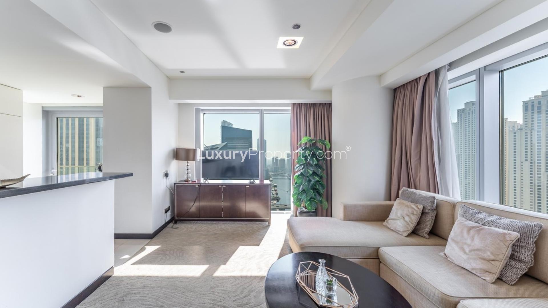 Furnished apartment with marina views, cozy living area, and dining space in Dubai Marina