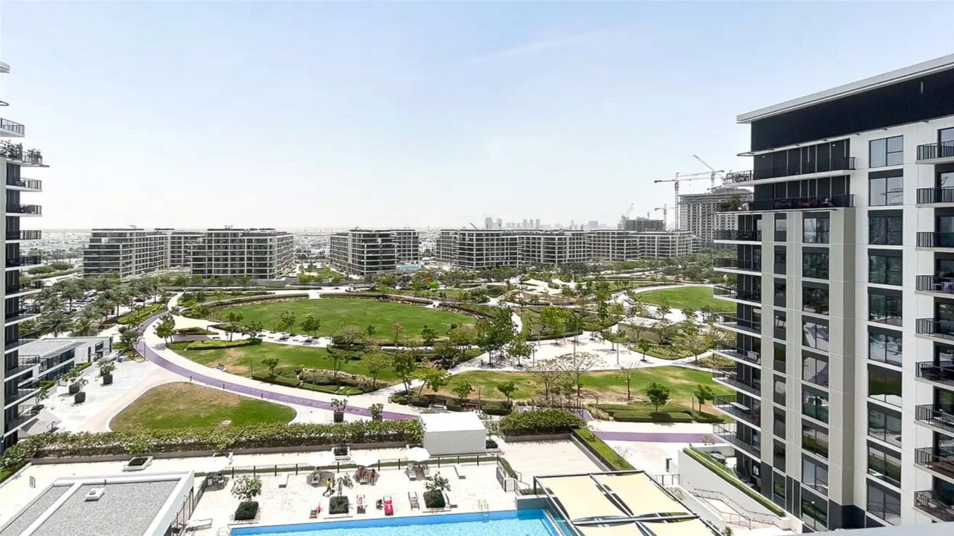 Empty living room with large window and balcony in Dubai Hills Estate apartment