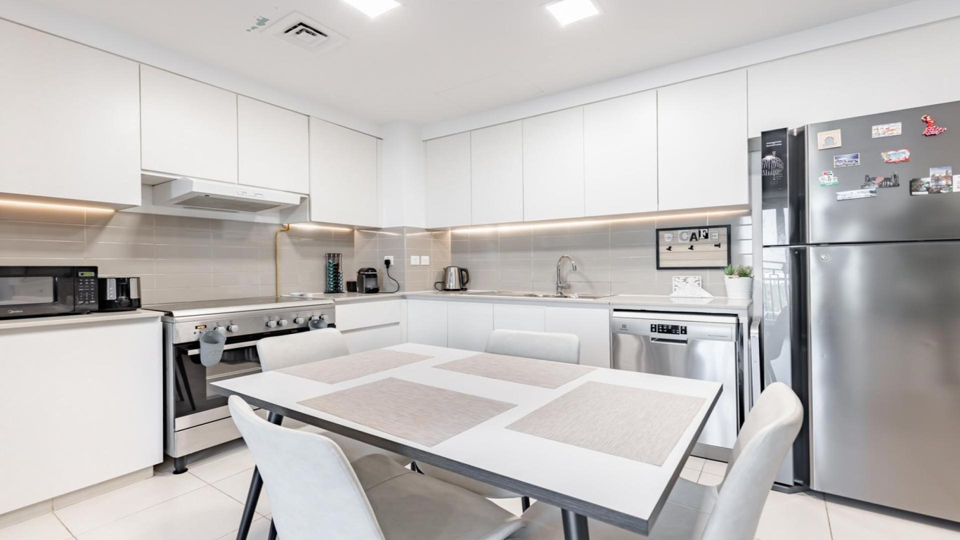 Modern kitchen in stylish 2-bedroom Zahra Breeze apartment, Town Square, for sale