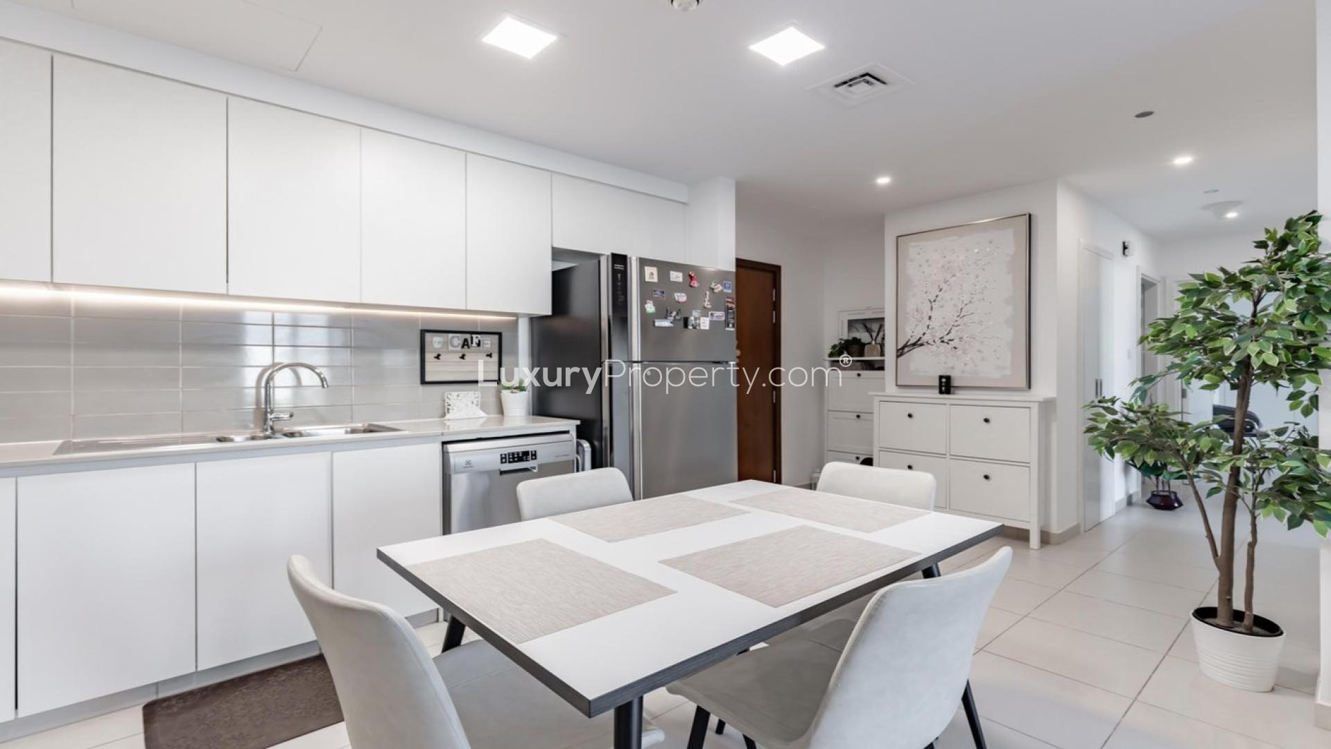 Modern kitchen and living area in Zahra Breeze 2-bedroom apartment, Town Square