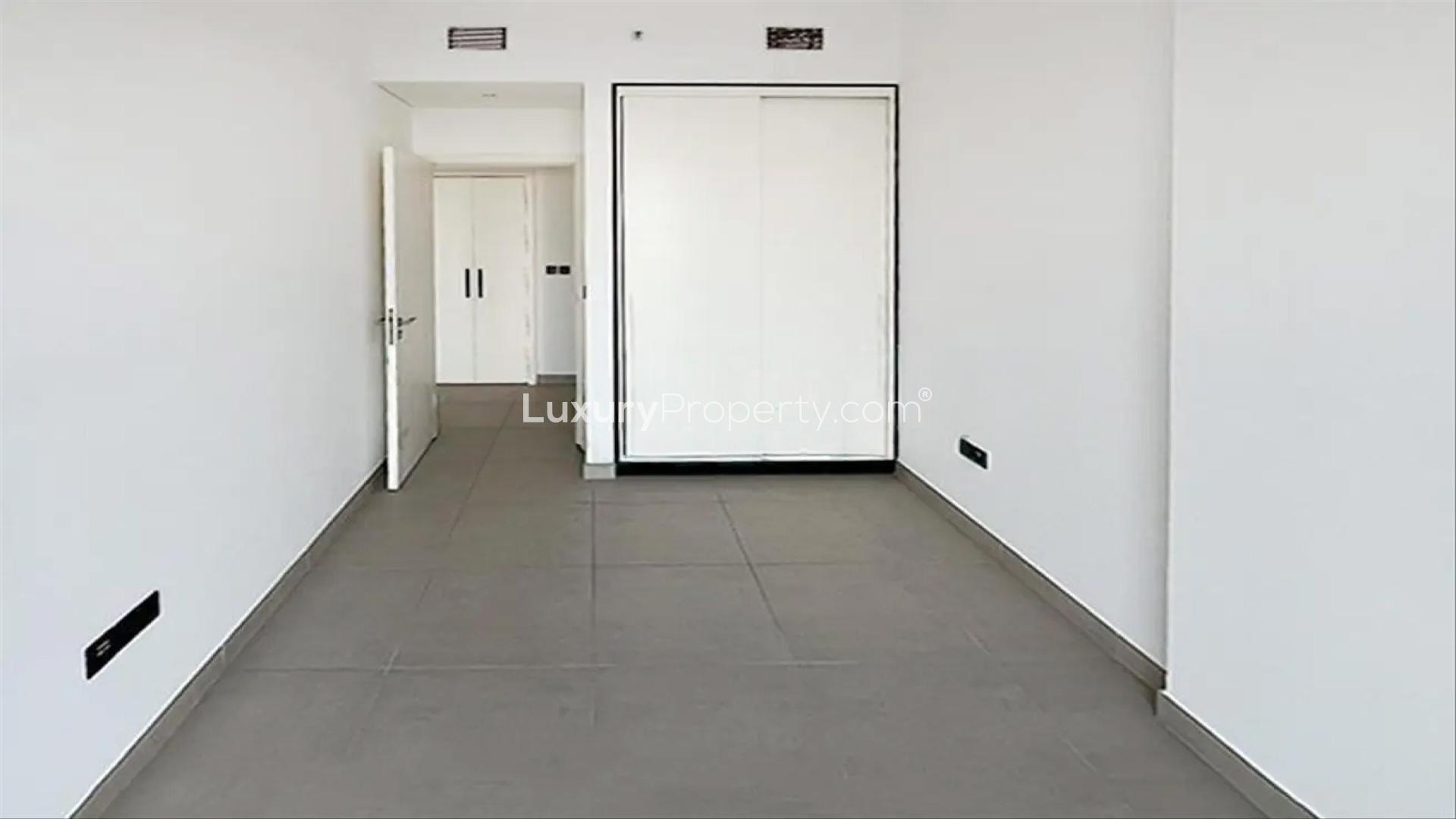 Empty bedroom with built-in wardrobe in Dubai Hills Estate apartment for sale