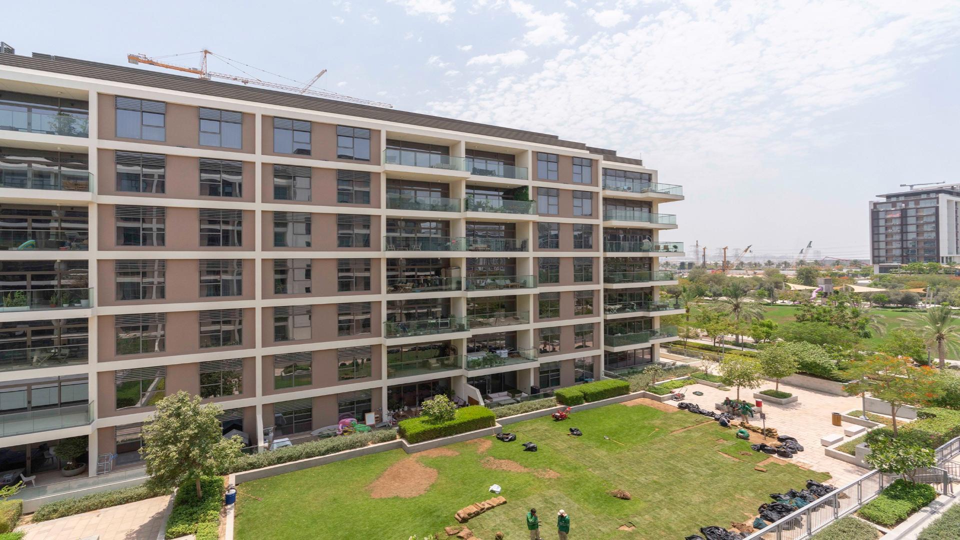 Modern kitchen with wooden cabinets in Dubai Hills Estate apartment, Park Heights