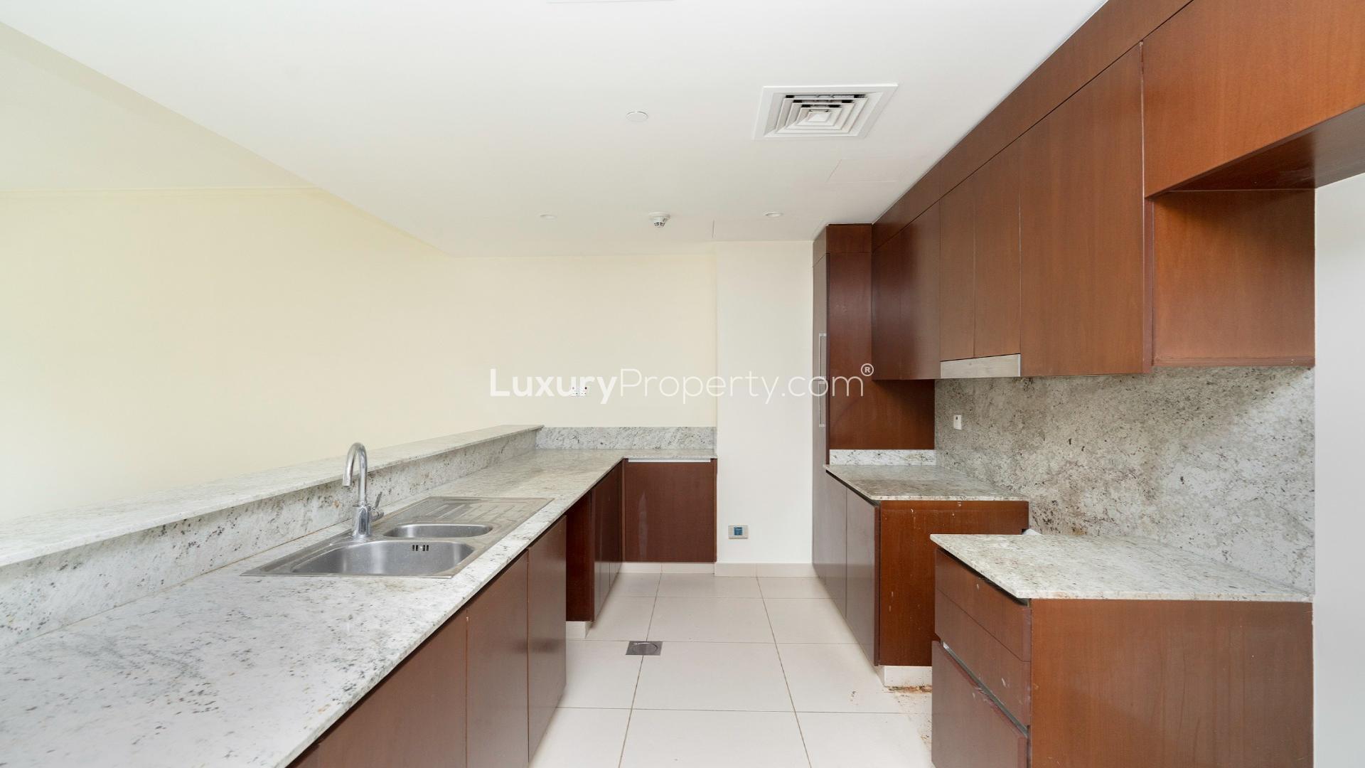 Modern living room in Dubai Hills Estate apartment with large windows and natural light