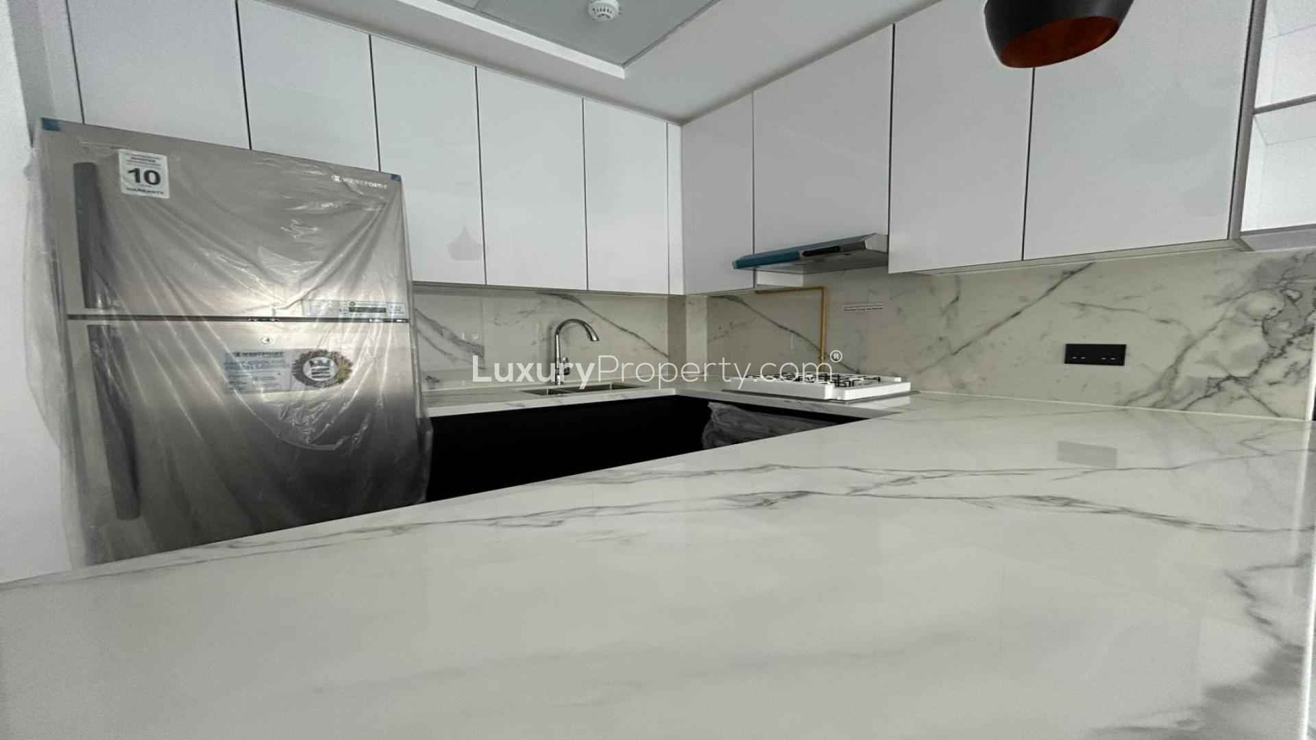 Modern open-plan living area in Arjan apartment with sleek flooring and kitchen view