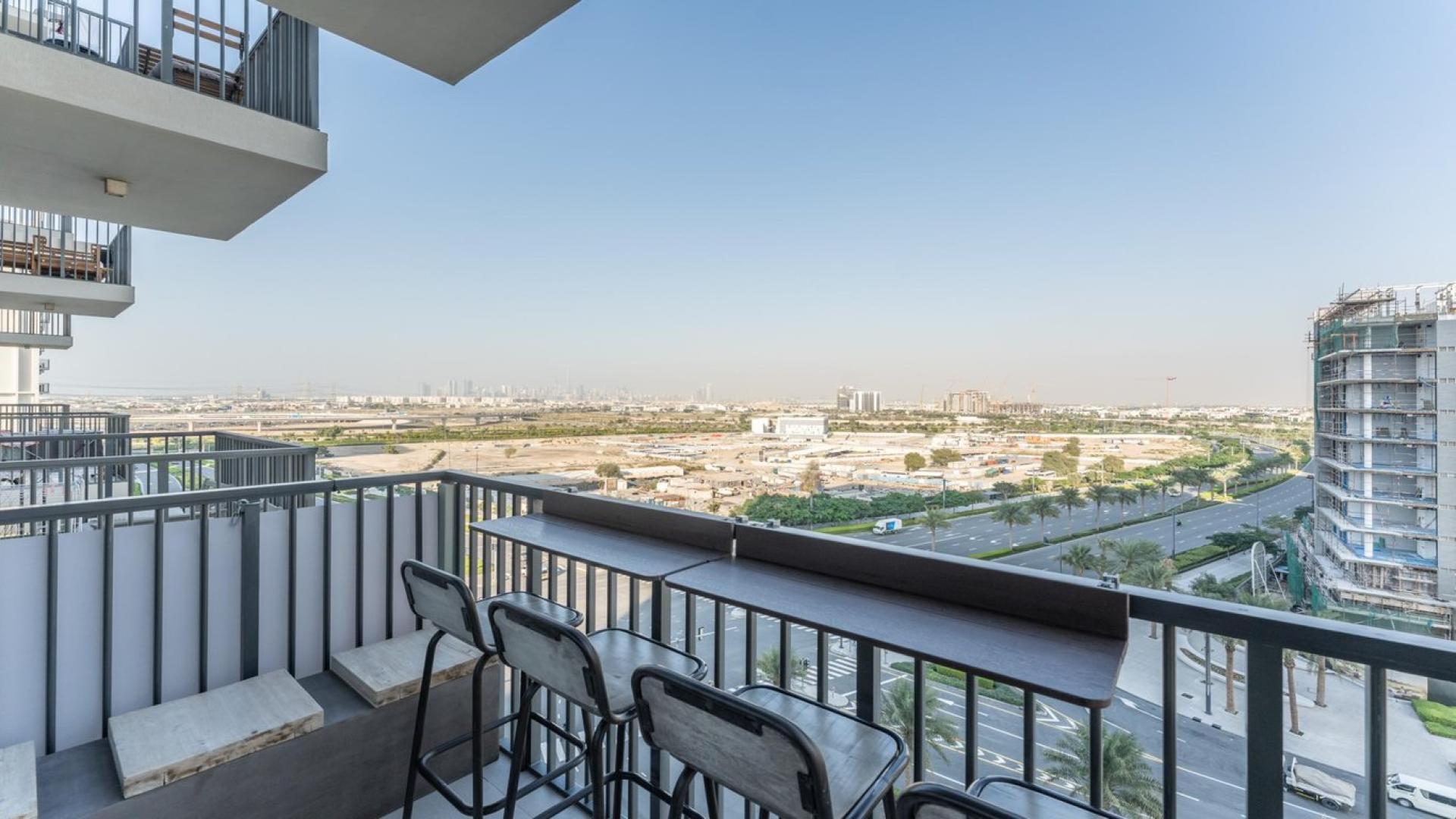 Upgraded living room in 2-bedroom apartment, Park Ridge, Dubai Hills Estate, modern decor, spacious balcony