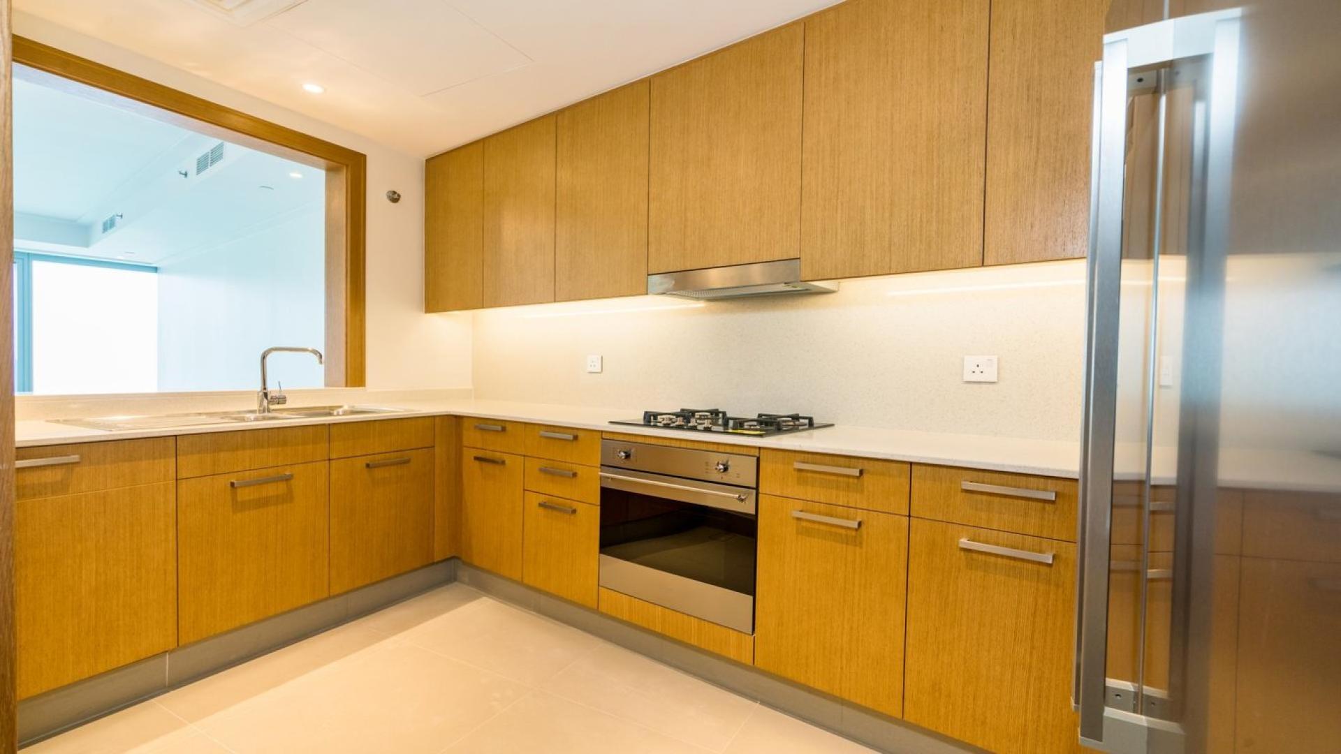 Modern kitchen in 2-bedroom apartment, Opera Grand, Downtown Dubai, featuring sleek appliances and cabinetry