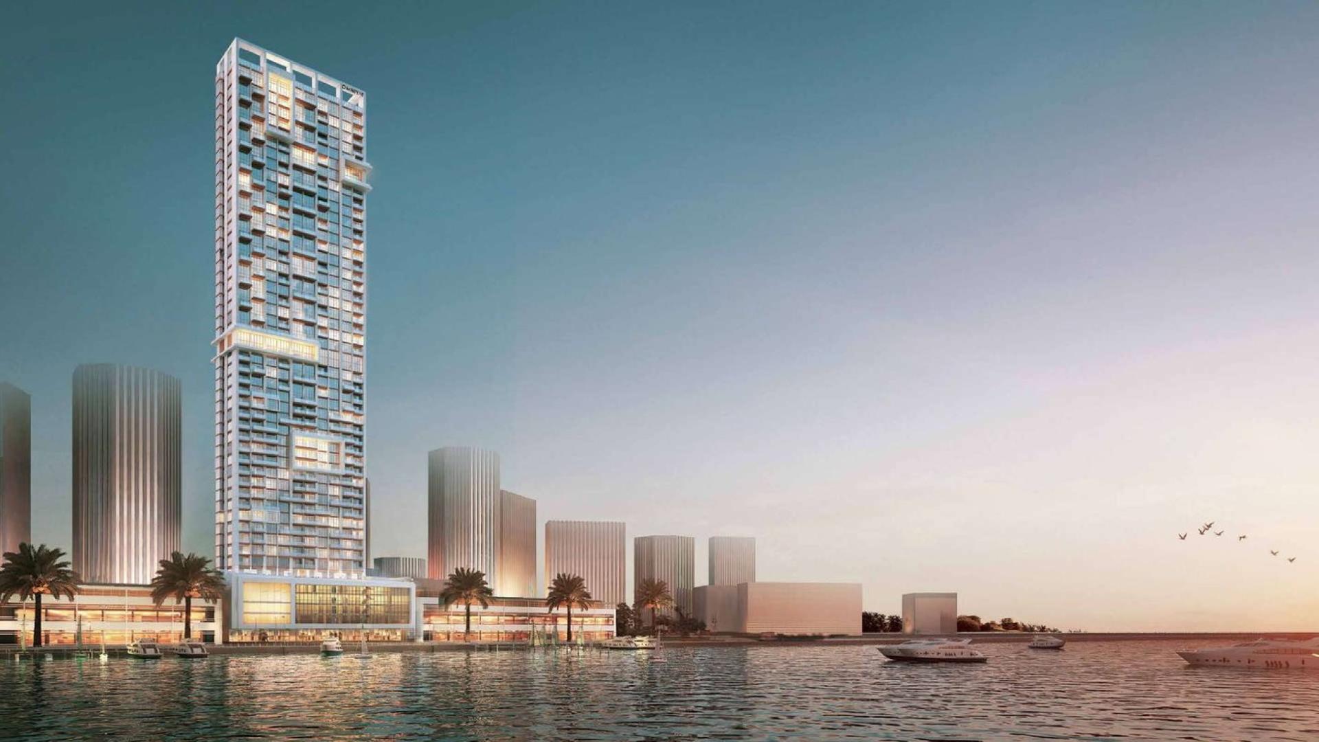 Luxurious penthouse building in Anwa, Dubai Maritime City, with waterfront views at sunset