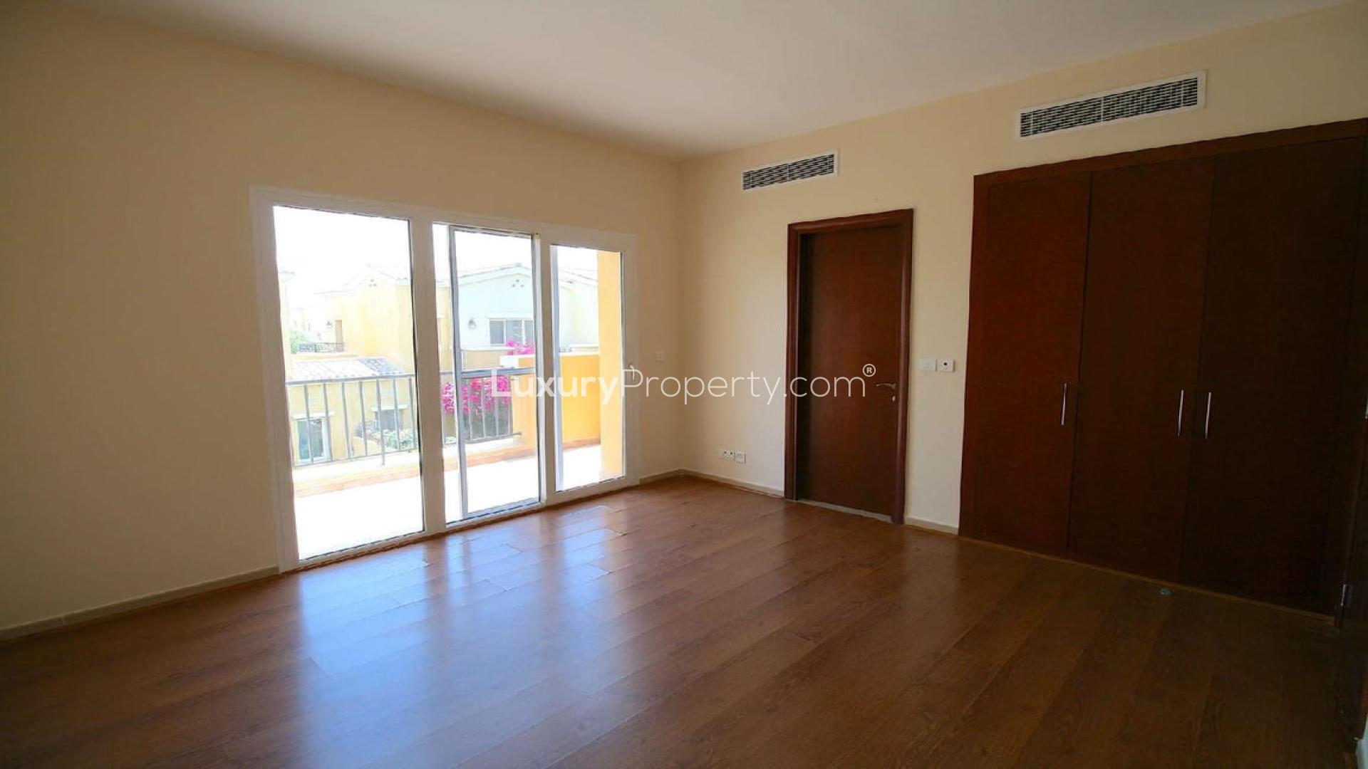 "Bright bedroom with wooden floors and balcony in Palmera townhouse, Arabian Ranches for rent.",Beautiful garden view of upgraded 2-bedroom townhouse in Palmera, Arabian Ranches for rent