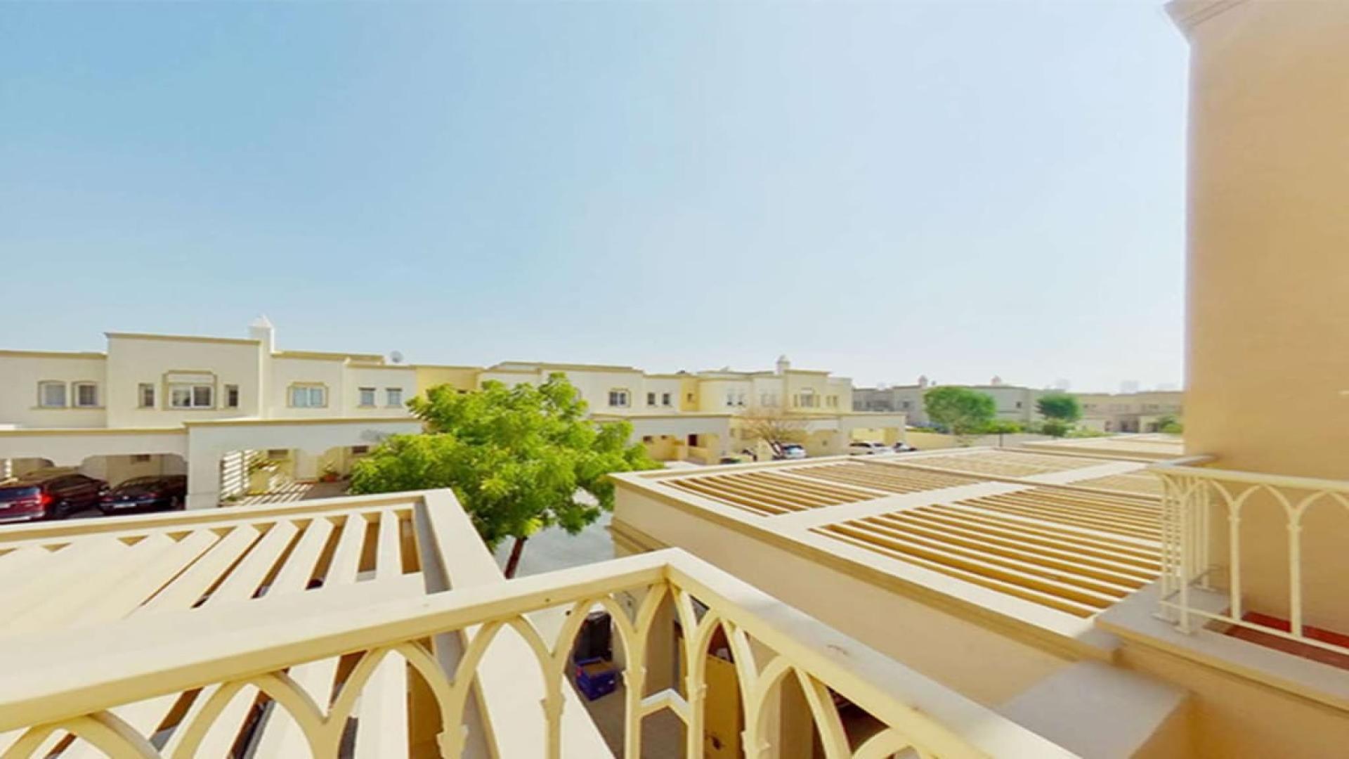 Modern kitchen in Springs 11 townhouse, featuring white cabinets and granite countertops