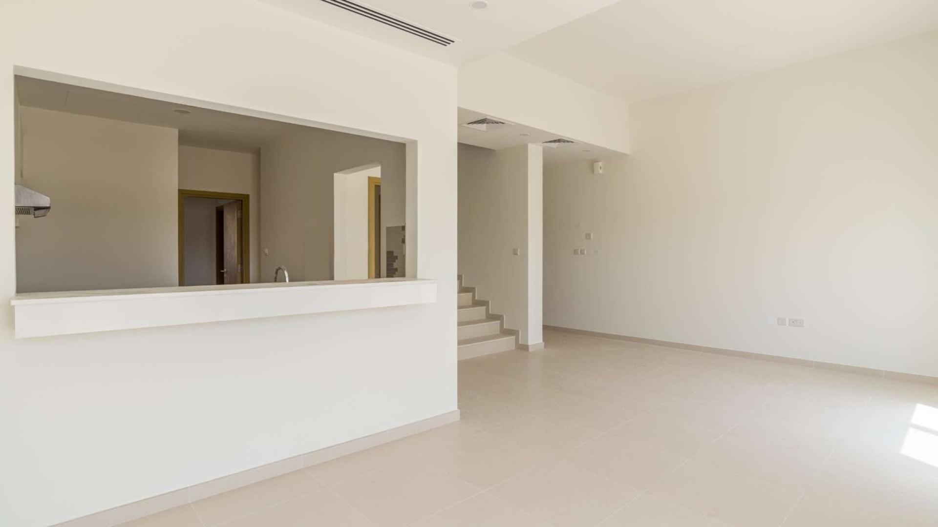 "Backyard view of 2-bedroom townhouse for sale in Amaranta 1, Villanova, Dubai.",Spacious living area in Amaranta 1 townhouse, Villanova, Dubai, featuring modern open-plan design