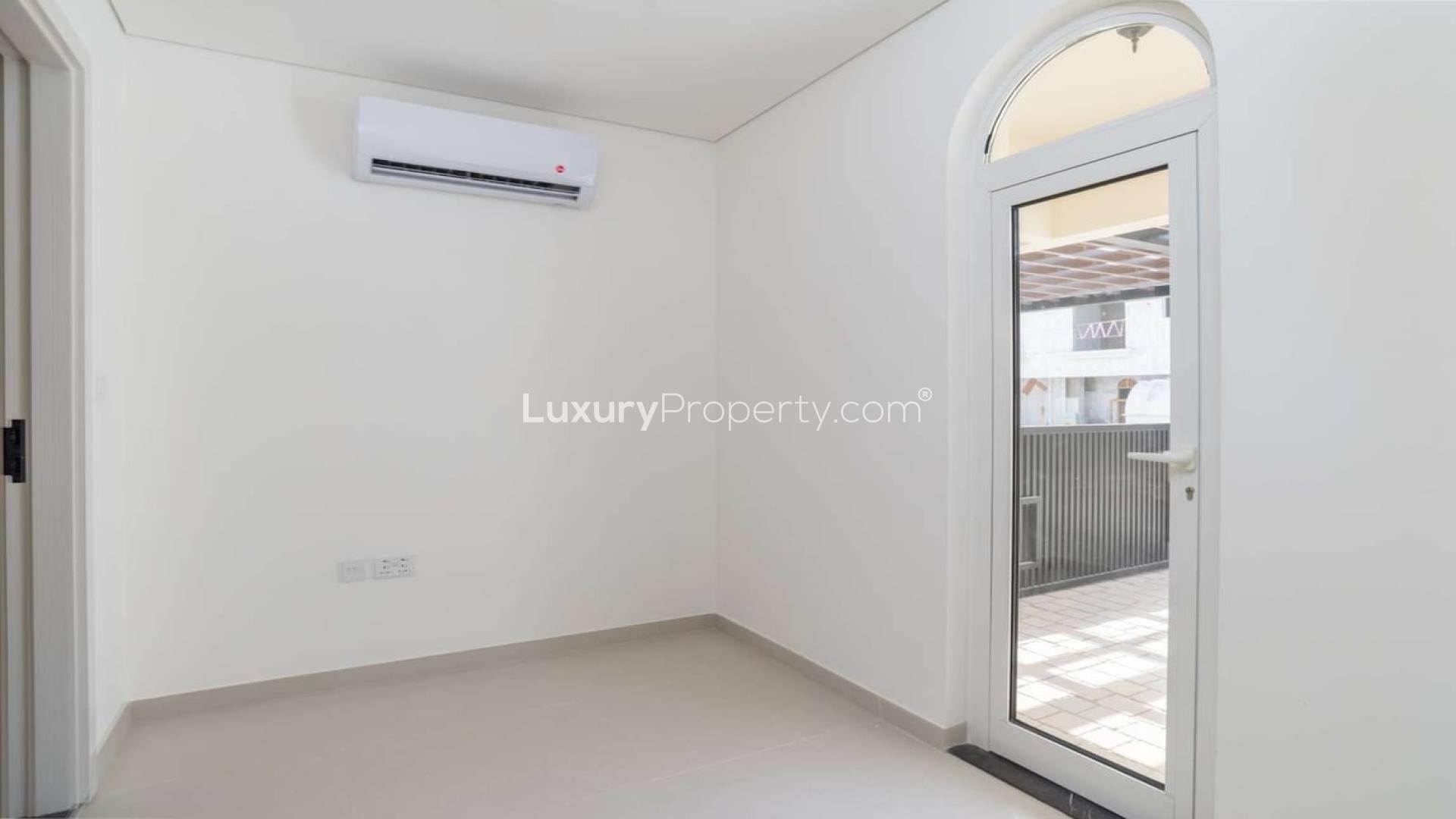 Modern open-plan kitchen and living area in Zafran Townhouses, Jumeirah Golf Estates