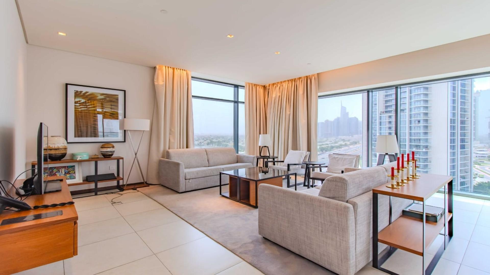 Spacious living room in 2-bedroom apartment, Vida Hotel, The Hills, with modern decor and balcony