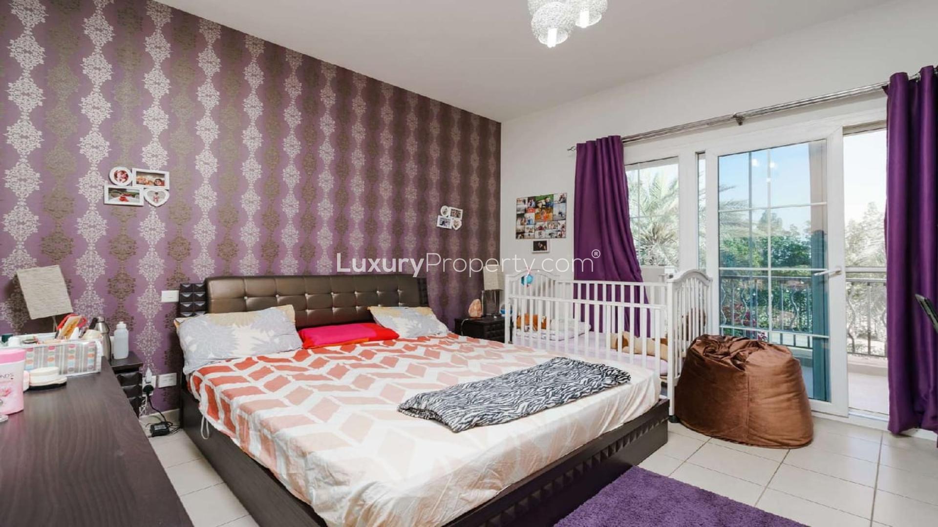 Modern kitchen in renovated Palmera Villa, Arabian Ranches, featuring sleek white cabinets and island