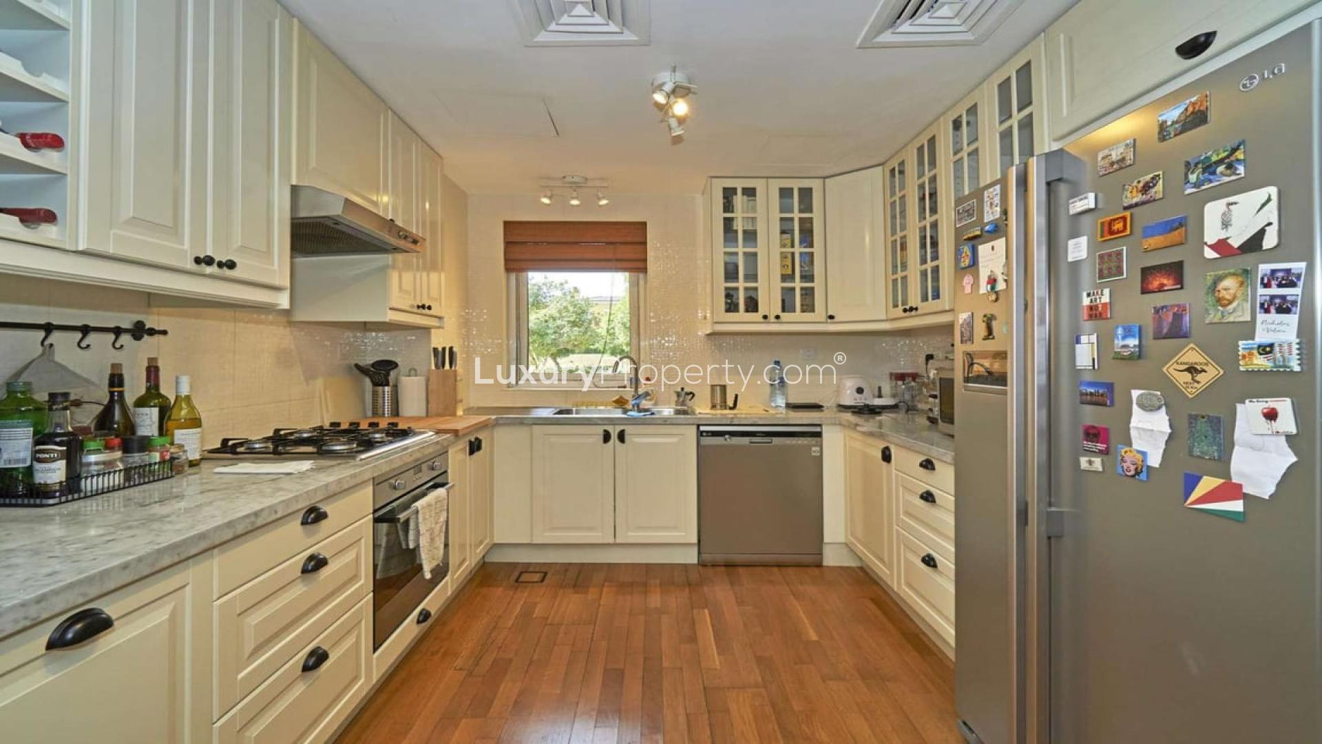 "Modern kitchen in 2-bedroom villa for rent, Palmera, Arabian Ranches, with wooden flooring.",Living room in 2-bedroom villa, Palmera, Arabian Ranches, with modern decor and staircase