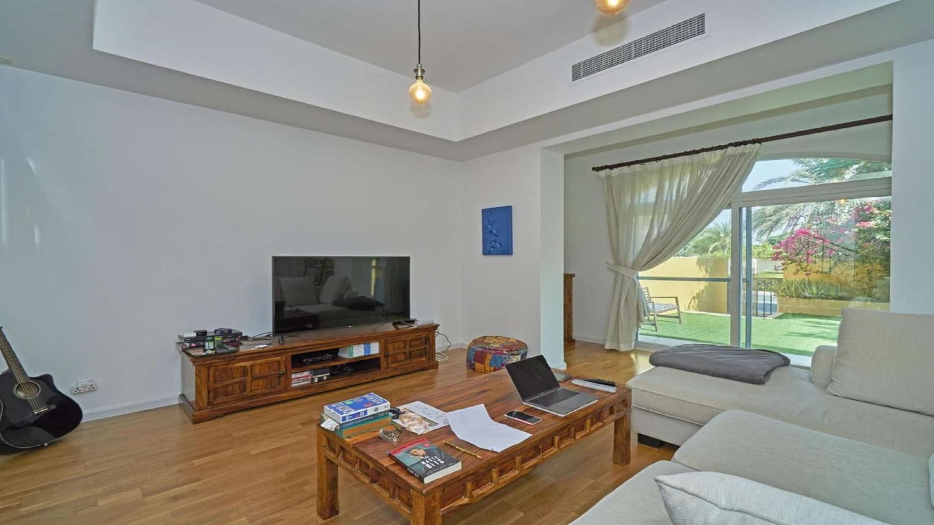 Living room with garden view in 2-bedroom villa, Palmera, Arabian Ranches