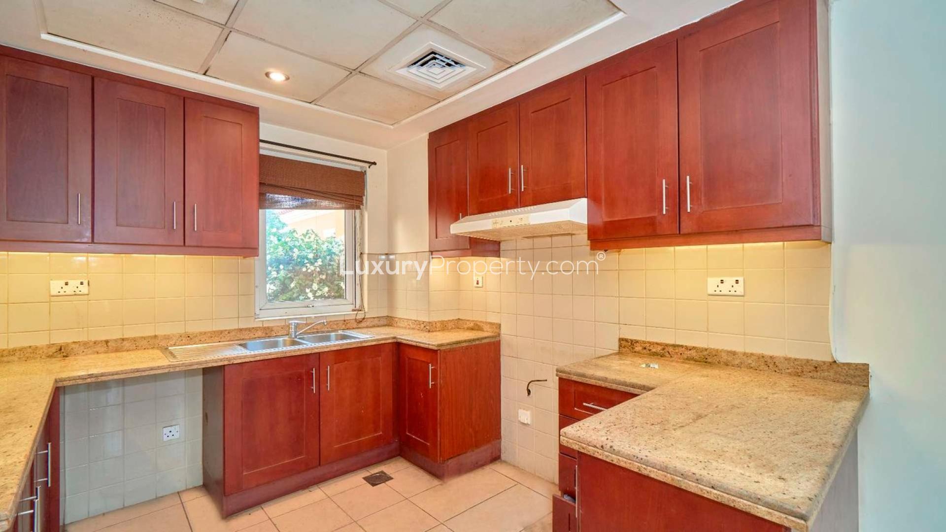 "View from 2-bedroom villa in Palmera 2, Arabian Ranches, with lush garden and road.",Spacious kitchen in 2-bedroom villa for rent, Palmera 2, Arabian Ranches