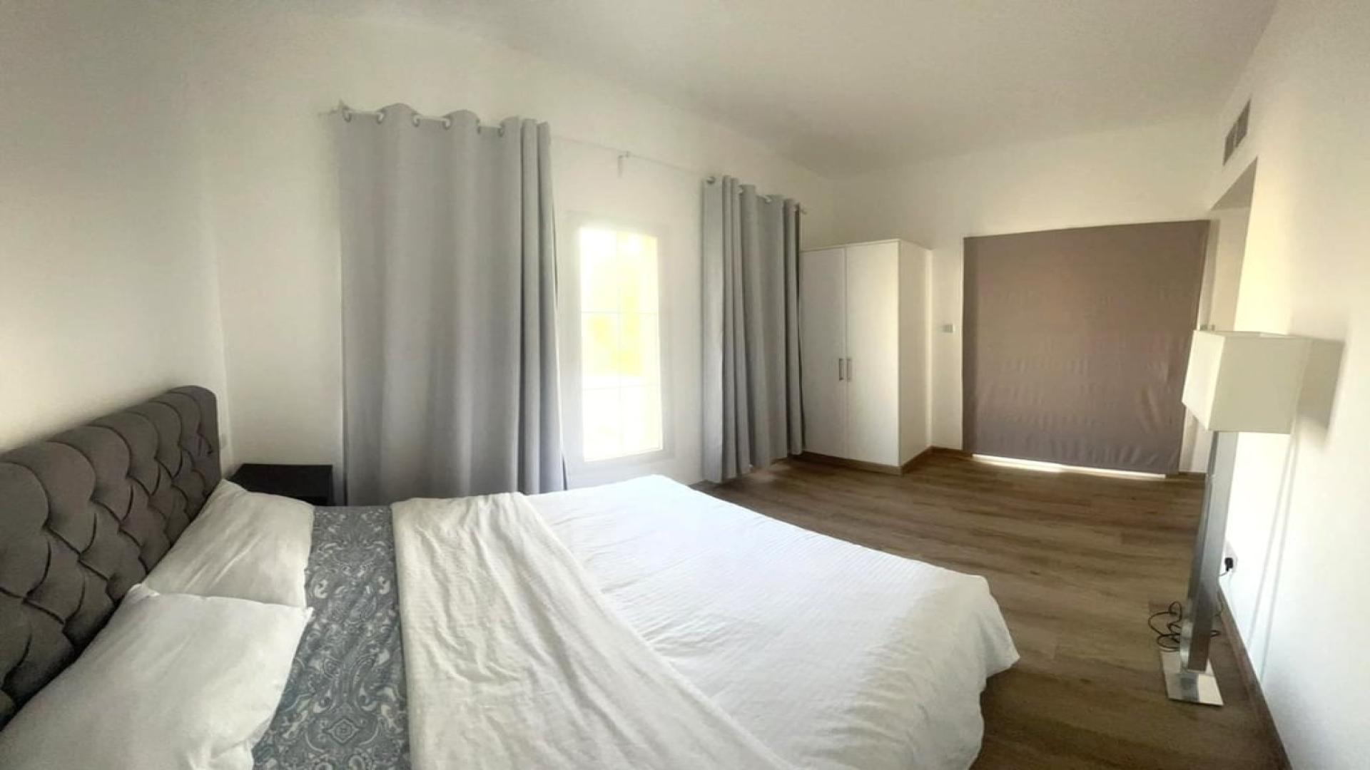 Furnished bedroom with large window in Springs 7 villa for rent, bright and spacious