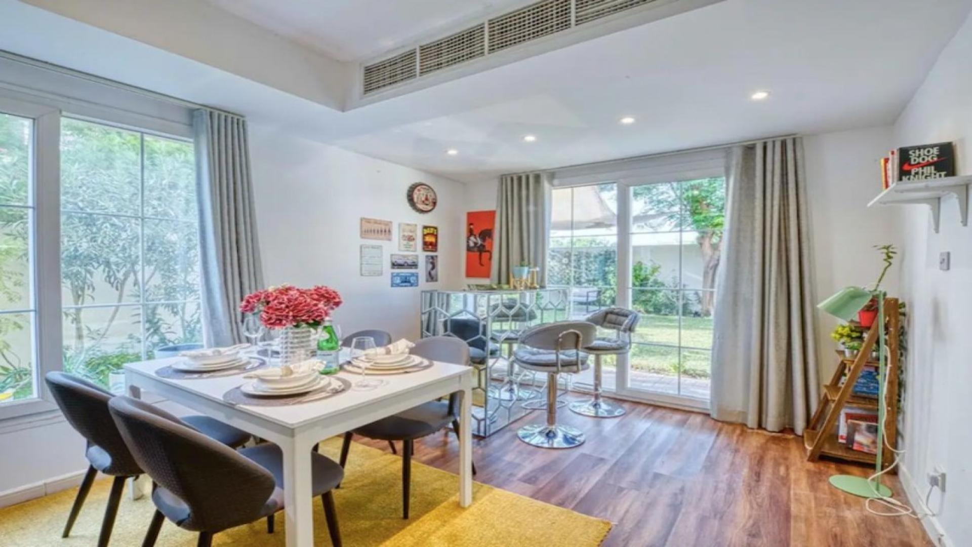 Charming living room in 2-bedroom villa, Springs 11, featuring modern decor and garden view