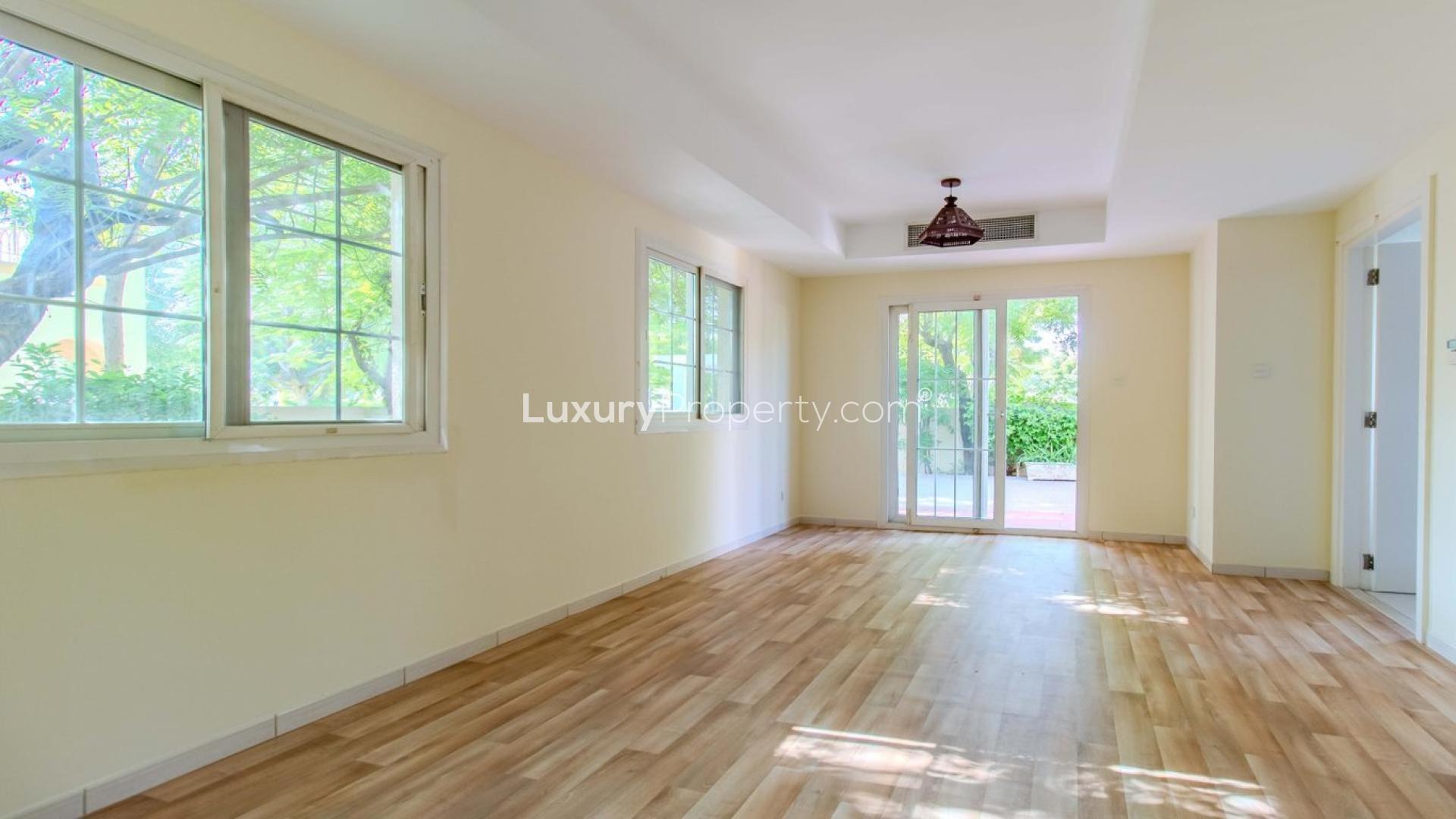 "Villa balcony overlooking lush garden in Springs 12, ideal for family relaxation and enjoyment.",Bright living room with garden view in Springs 12 villa, available for rent