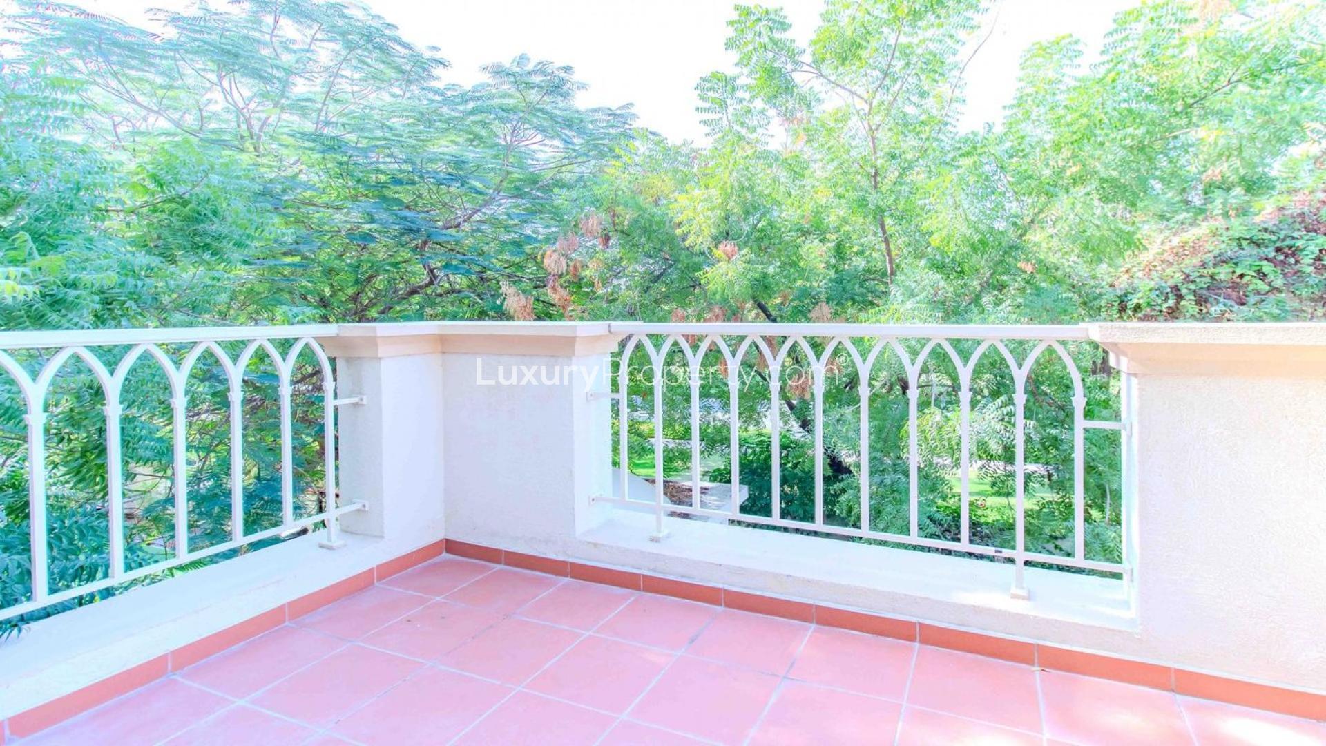Empty living room with wooden floor, large window, and garden view in Springs 12 villa
