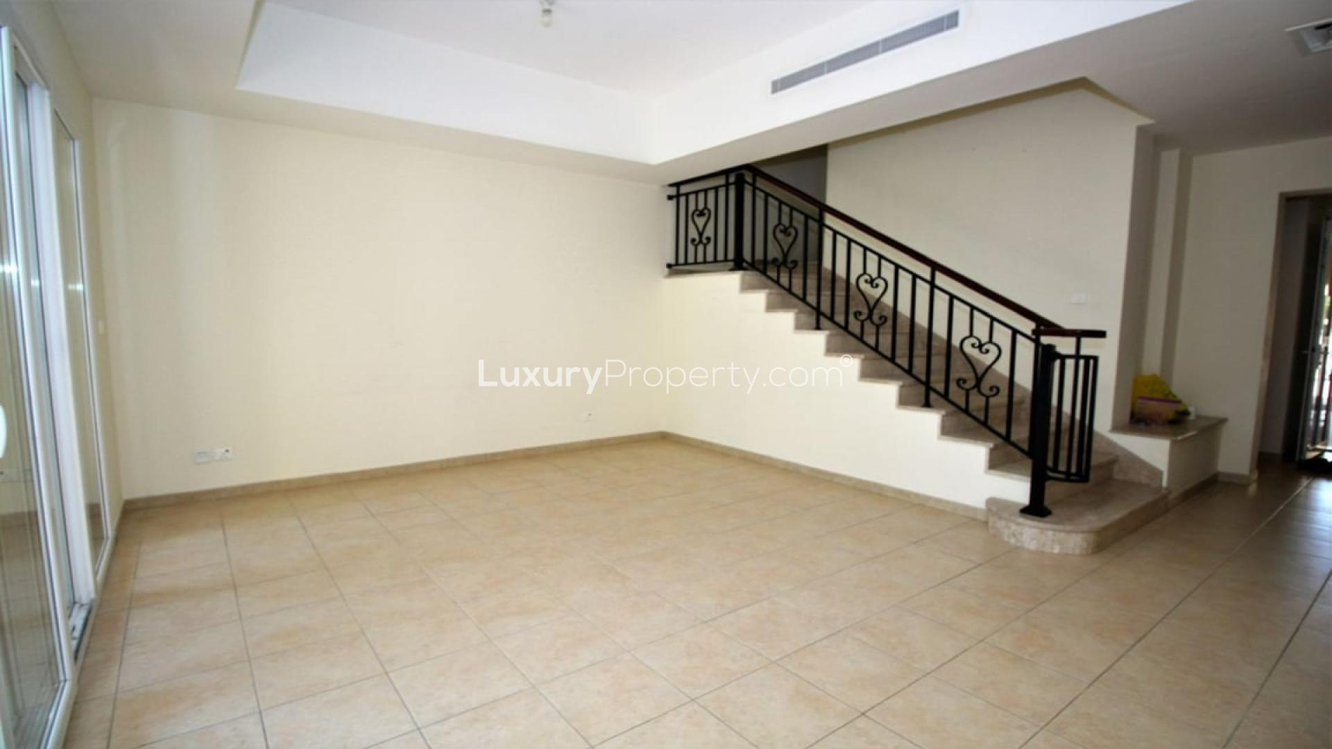 Single row 2-bedroom villa exterior in Palmera, Arabian Ranches, Dubai, with garden view