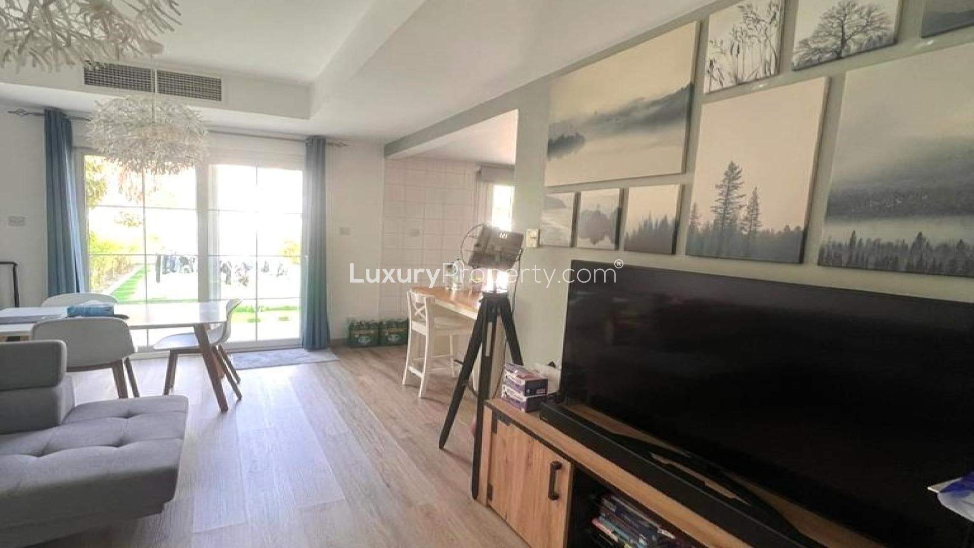 Fully furnished living room in 2-bedroom villa, Springs 7, Dubai, with garden view