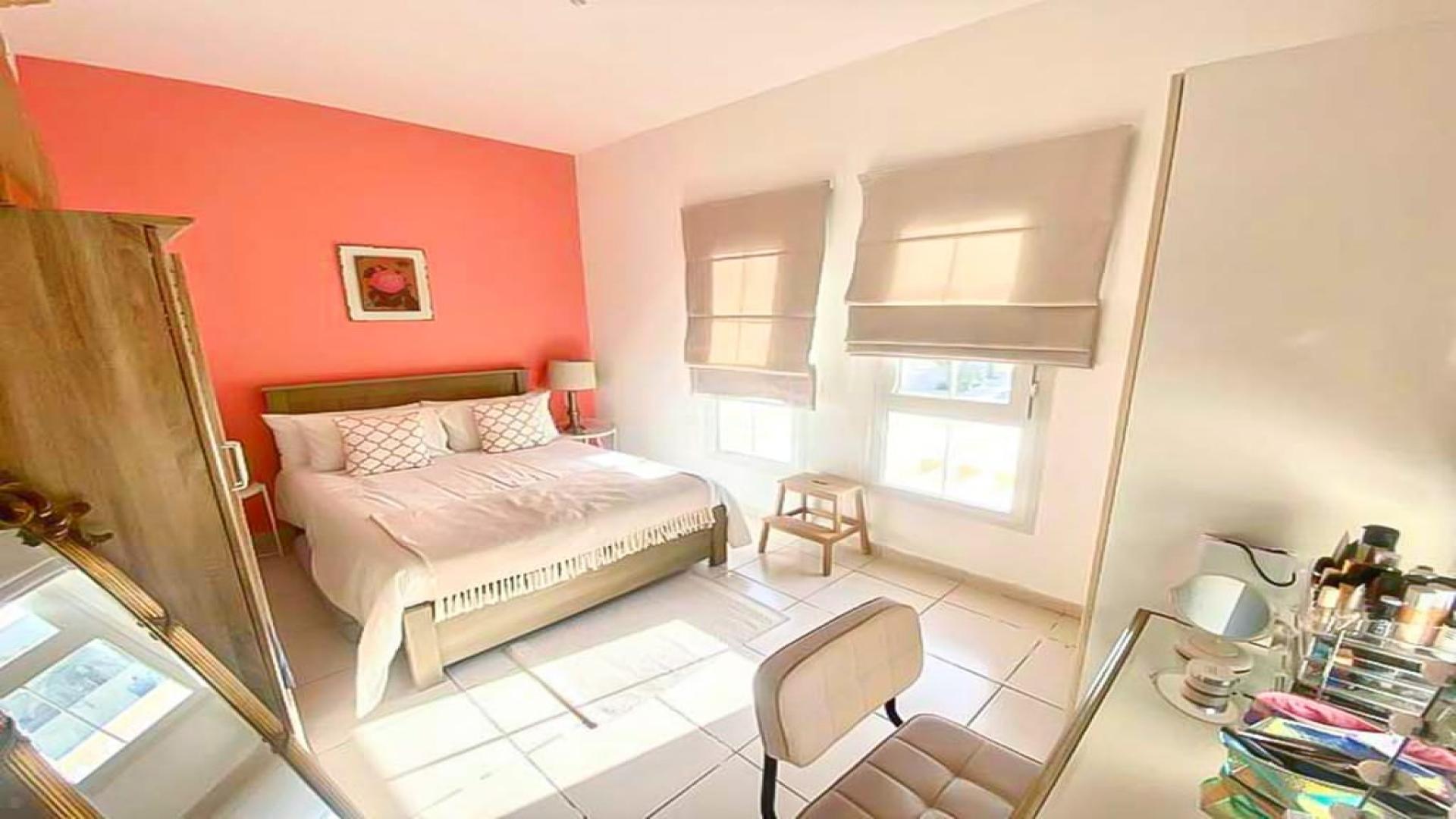 Bright bedroom with coral accent wall in 2-bedroom villa, Springs 3, Dubai