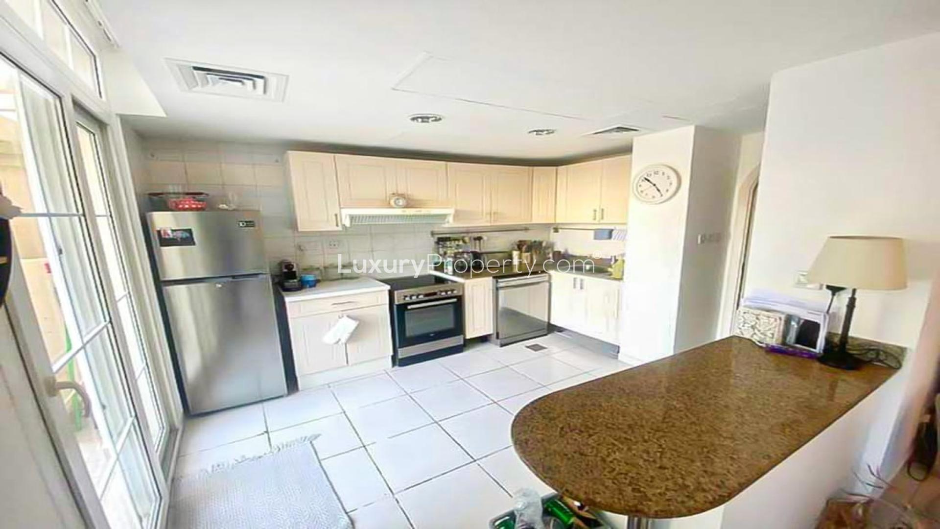 "Spacious living room in 2-bedroom villa for rent, Springs 3, Dubai, with modern decor.",Modern kitchen in 2-bedroom Type 4M villa, Springs 3, Dubai, available for rent