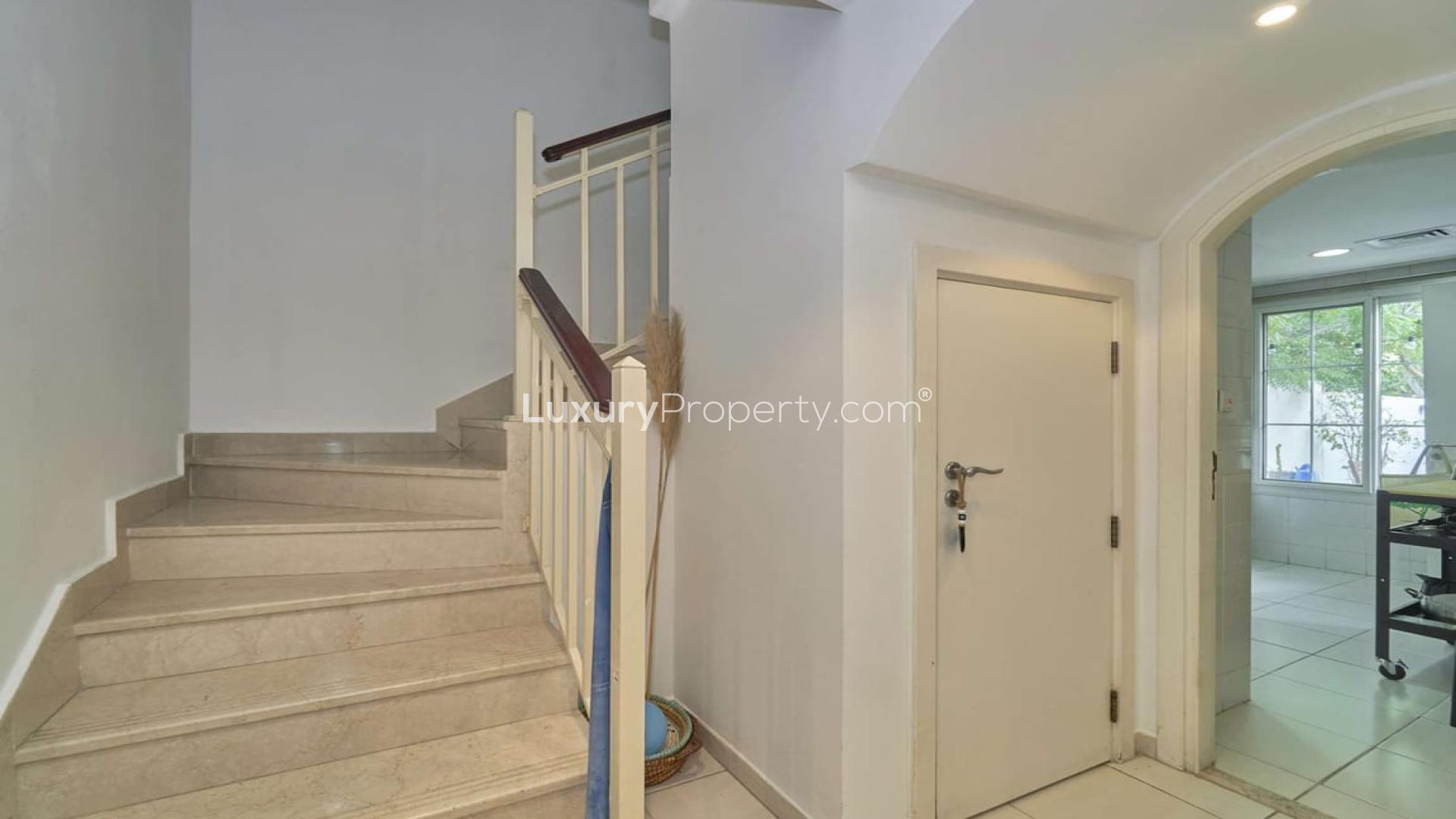 Cozy living area in Type 4M villa, Springs 12, featuring stylish decor and garden view
