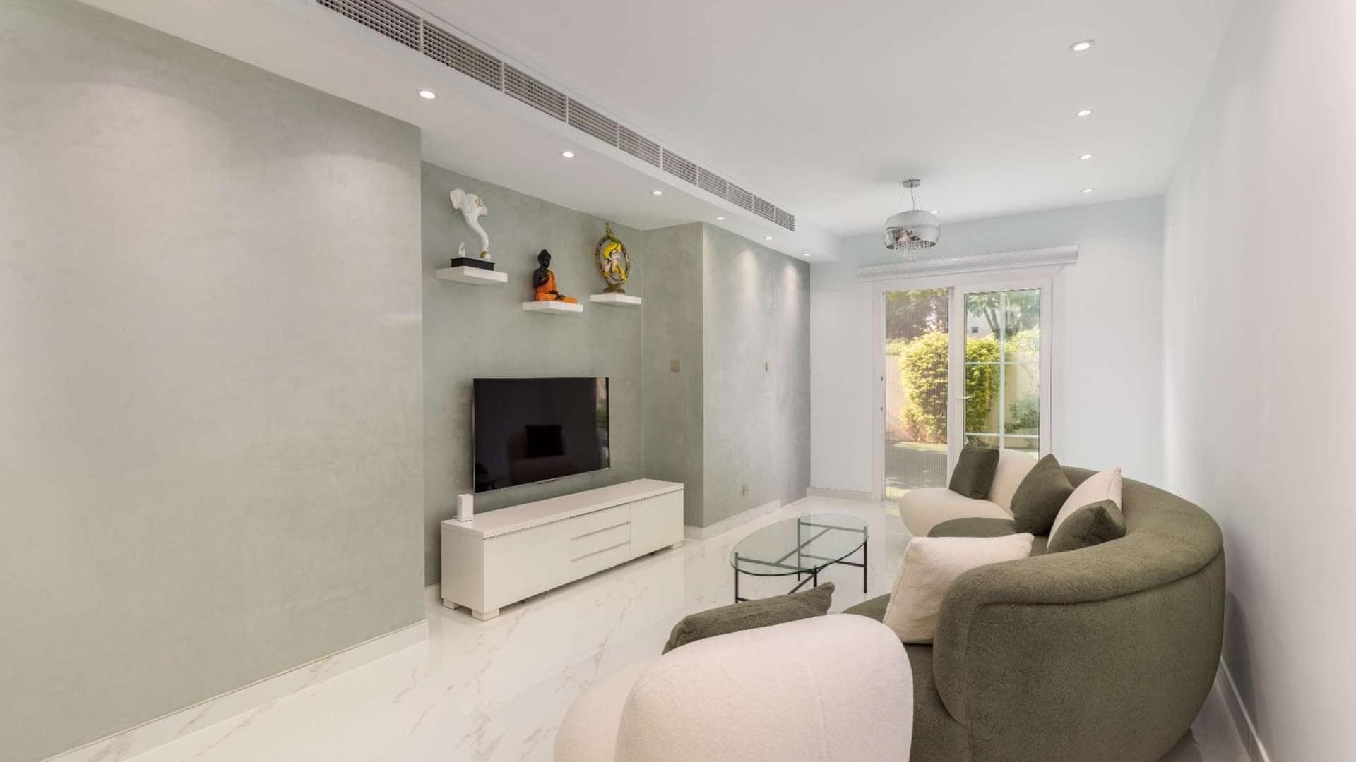 Modern living room in upgraded 2-bedroom villa, Springs 12, featuring stylish furniture and decor