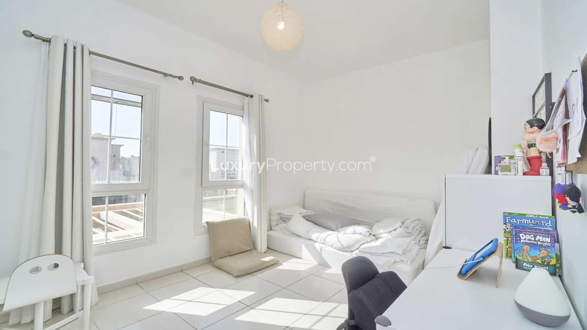 Living room in neat single row villa, Springs 3, featuring modern decor and natural light