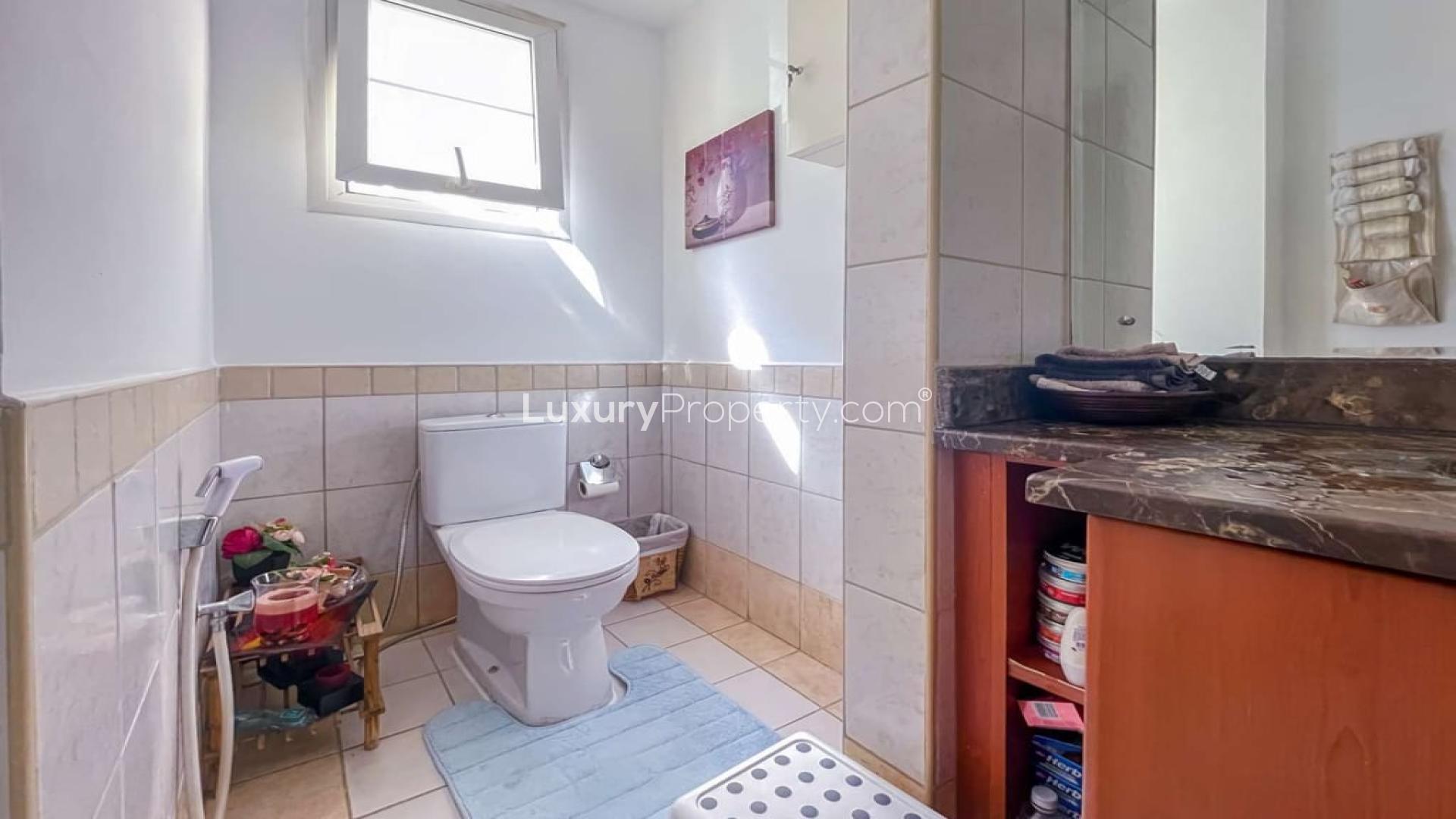 Living room in upgraded villa, Springs 12, with garden view through sliding doors