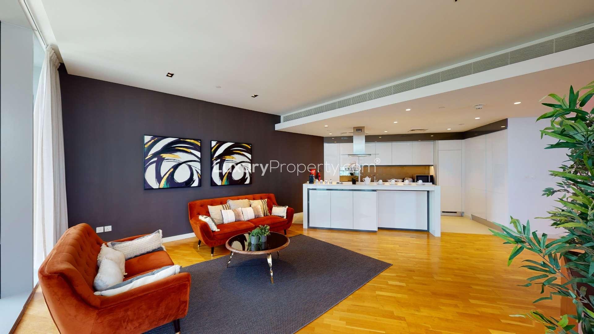 Furnished living and dining area in Bluewaters apartment, featuring modern decor and natural light