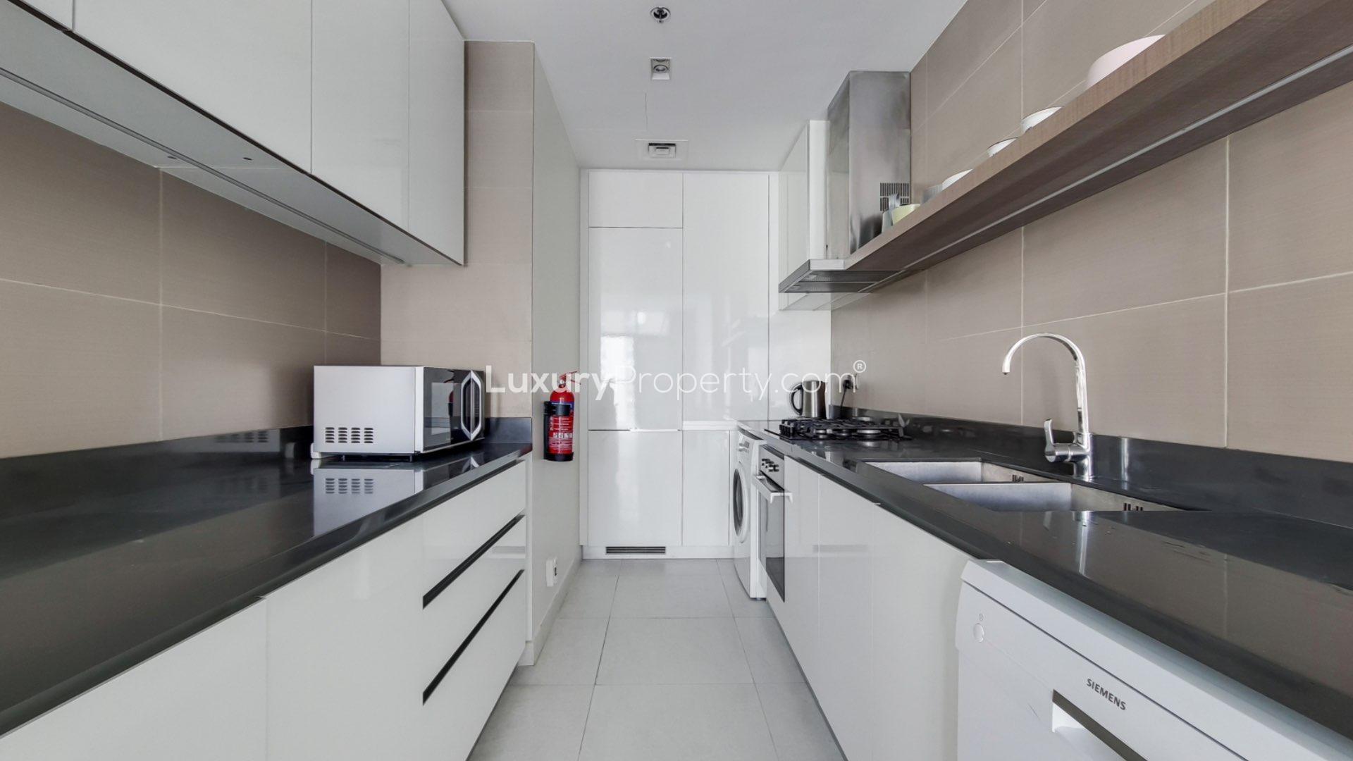 Fully furnished apartment living area with modern kitchen in Dubai Marina, Marina View