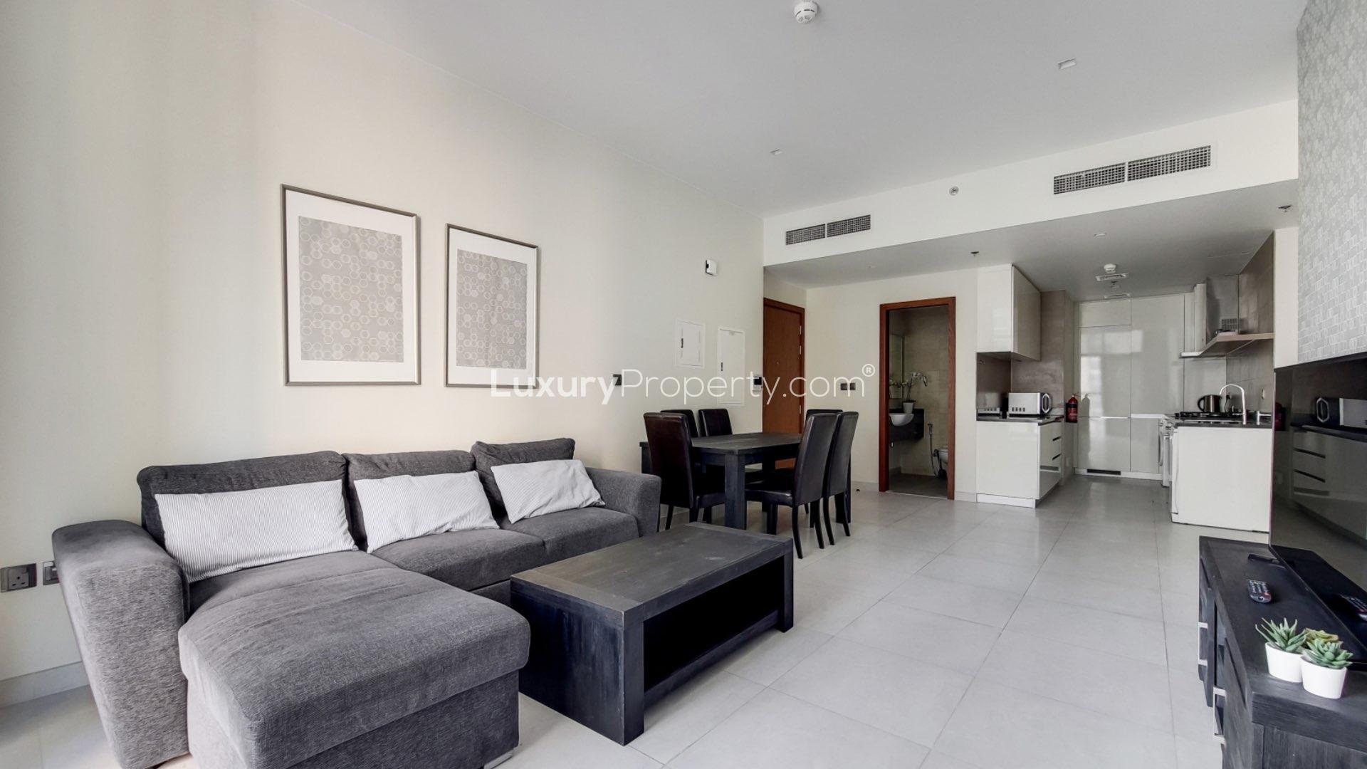 Fully furnished living room in Dubai Marina apartment with modern decor and large windows