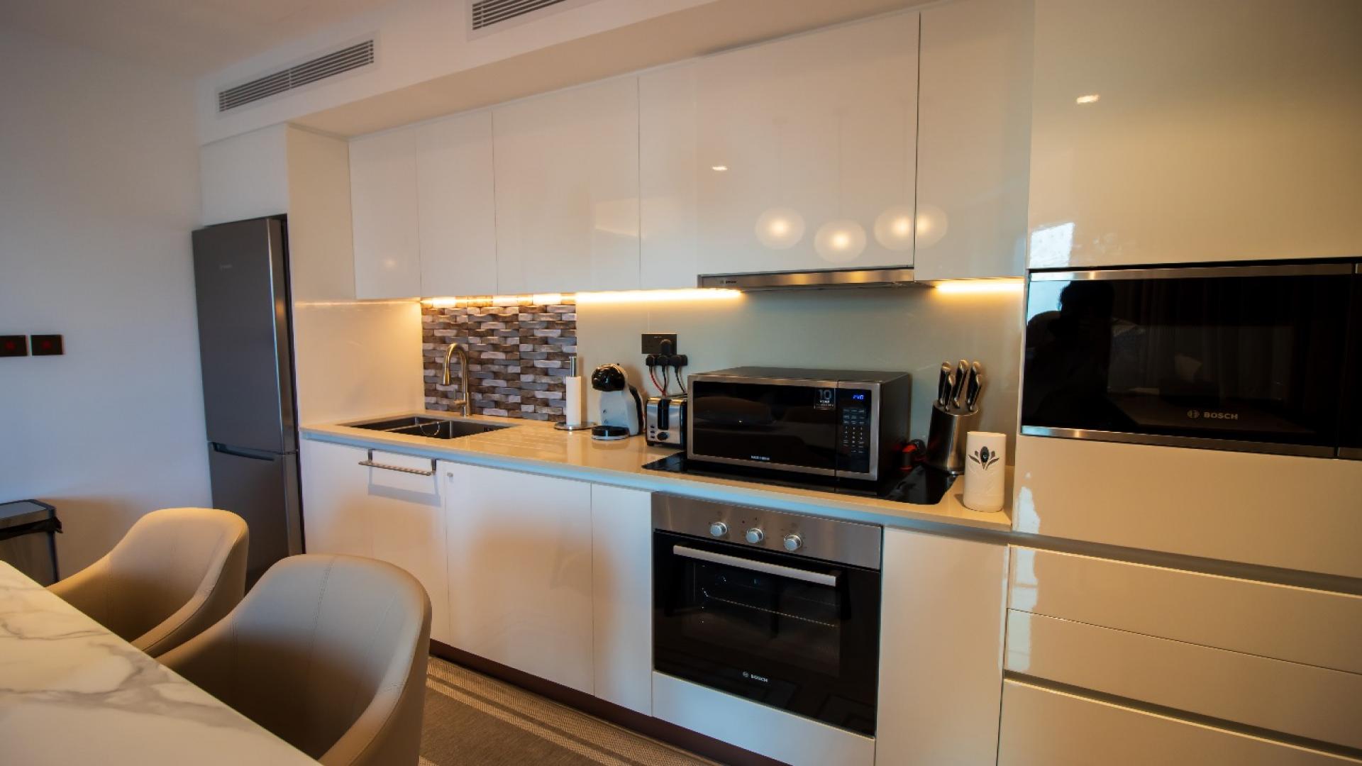 Modern kitchen in Dubai Creek Harbour apartment for rent, featuring sleek design and amenities