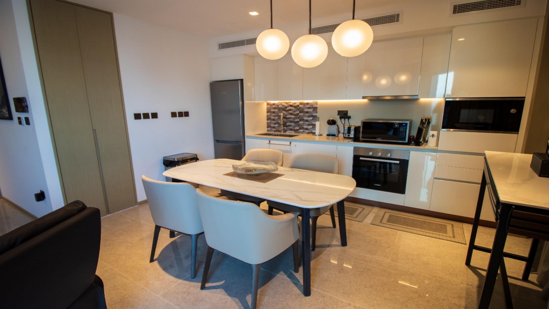Modern kitchen and dining area in Dubai Creek Harbour apartment, Address Harbour Point