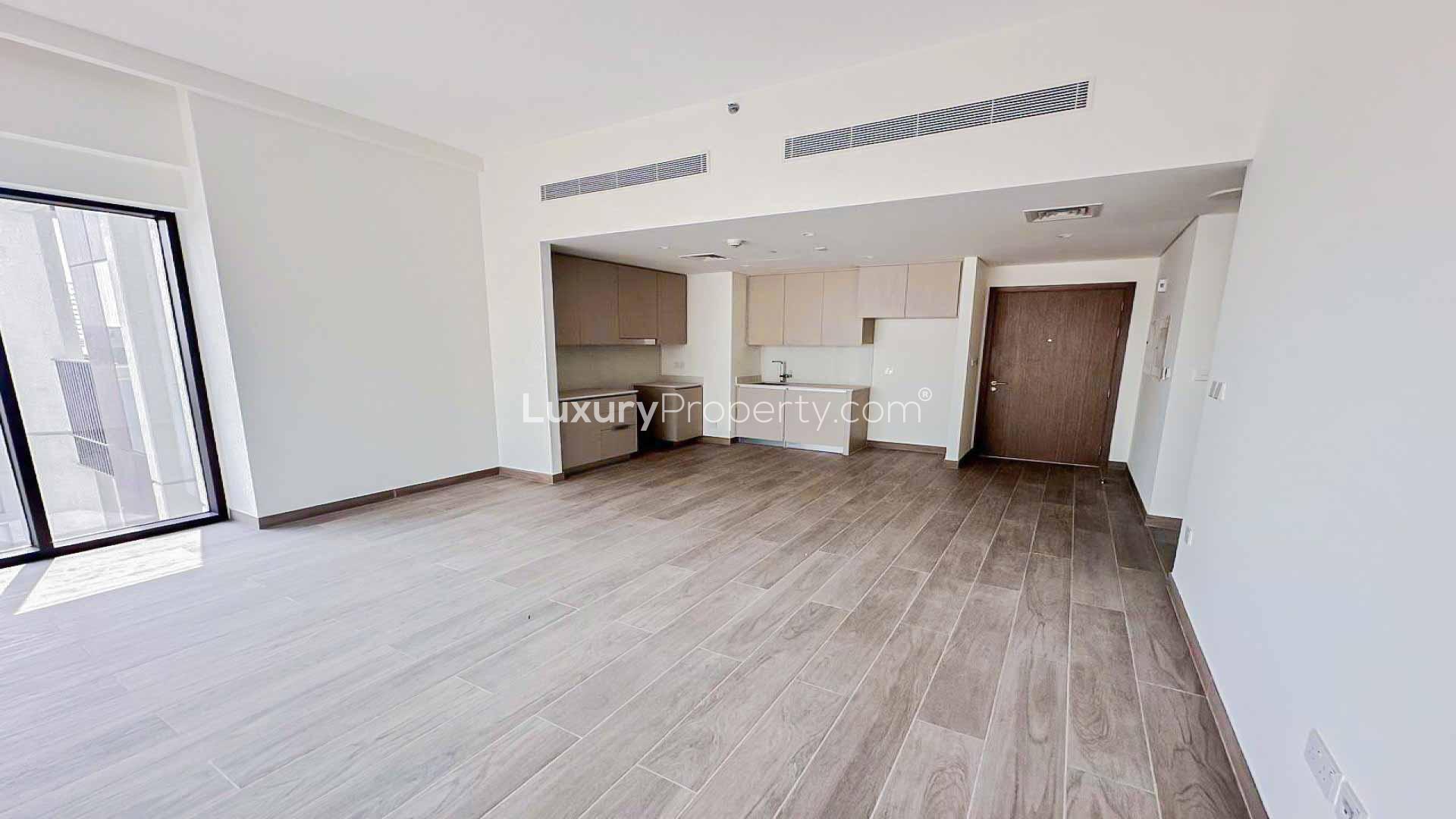Spacious living area with modern kitchen in Dubai Creek Harbour apartment for rent