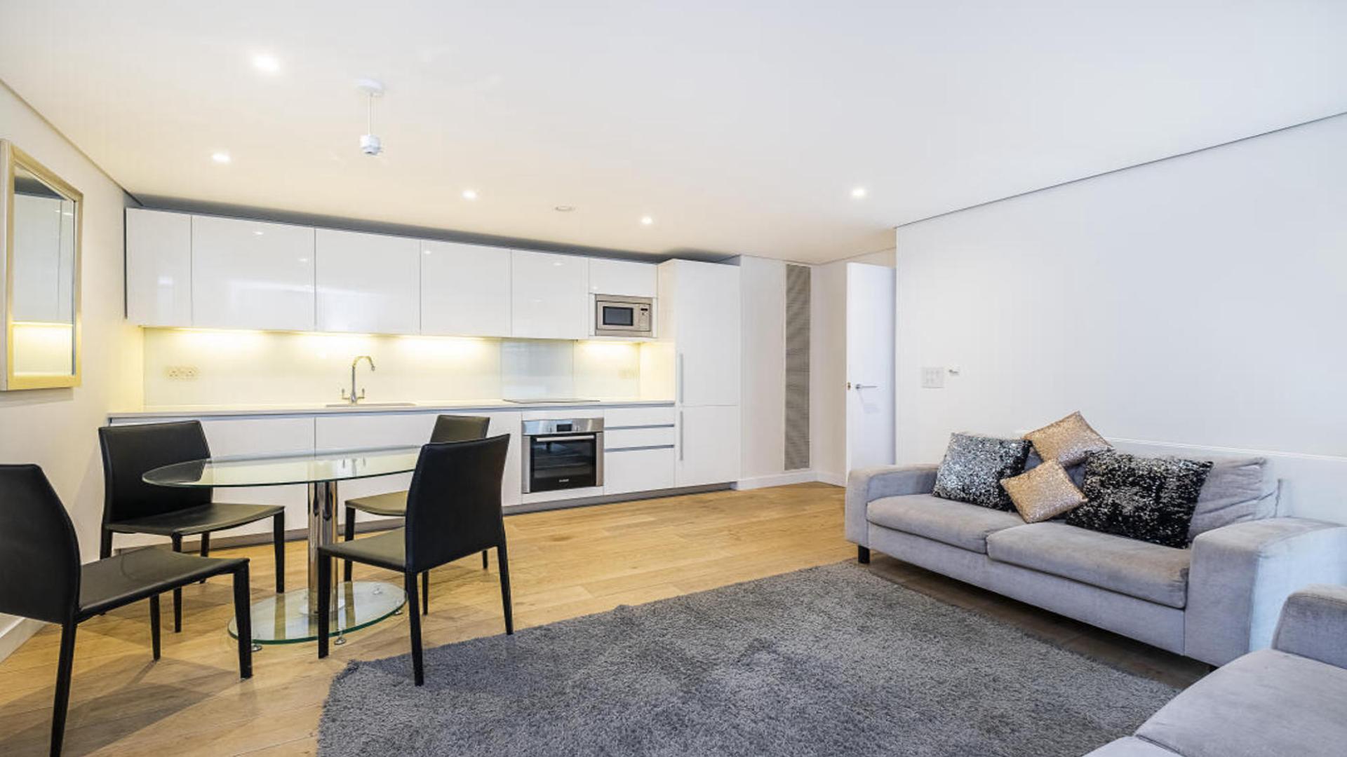 Modern kitchen in two-bedroom apartment, 4 Merchant Square, London, with sleek white cabinets