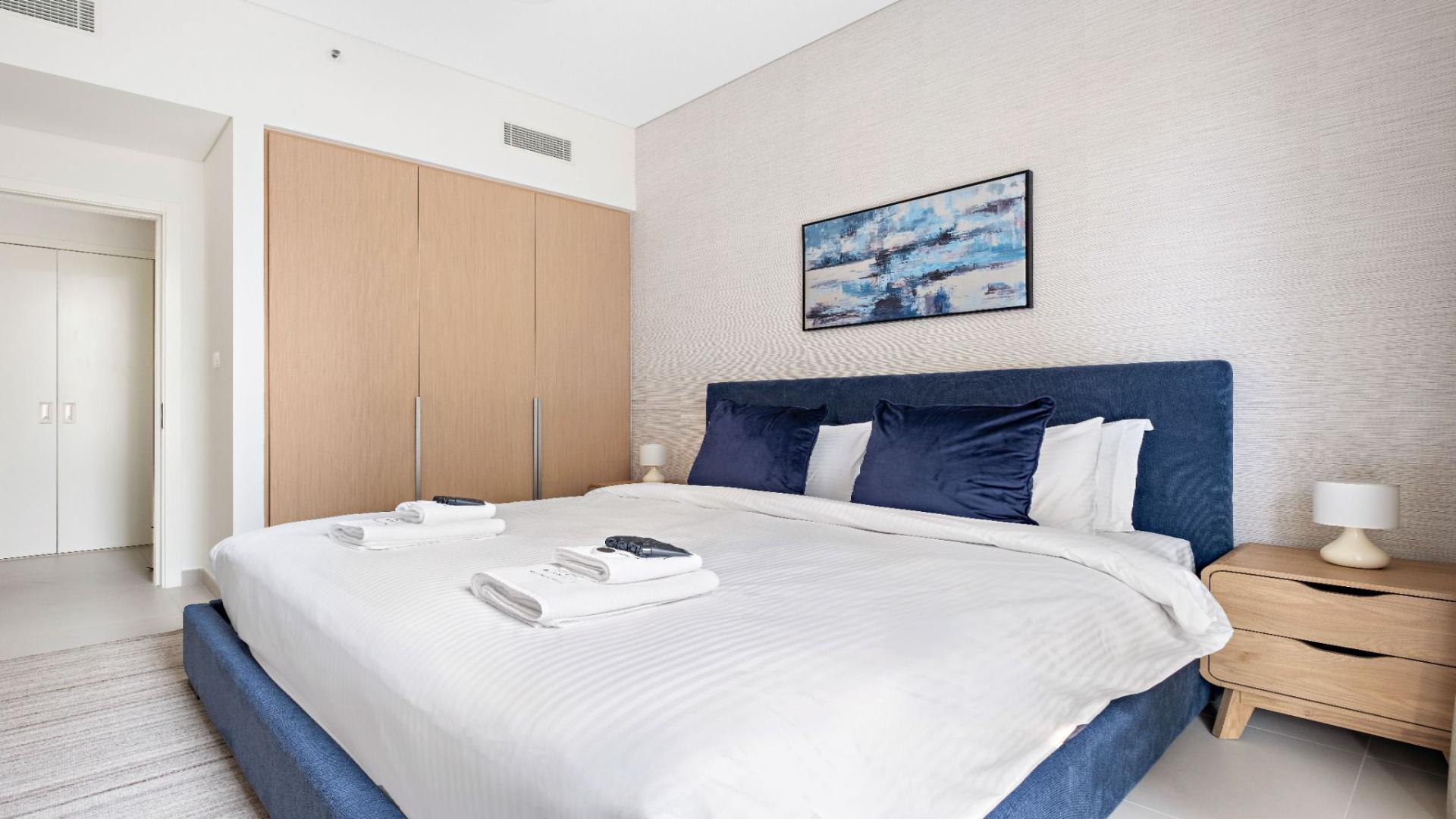 Modern living room in Dubai Creek Harbour apartment, featuring stylish decor and cozy seating area