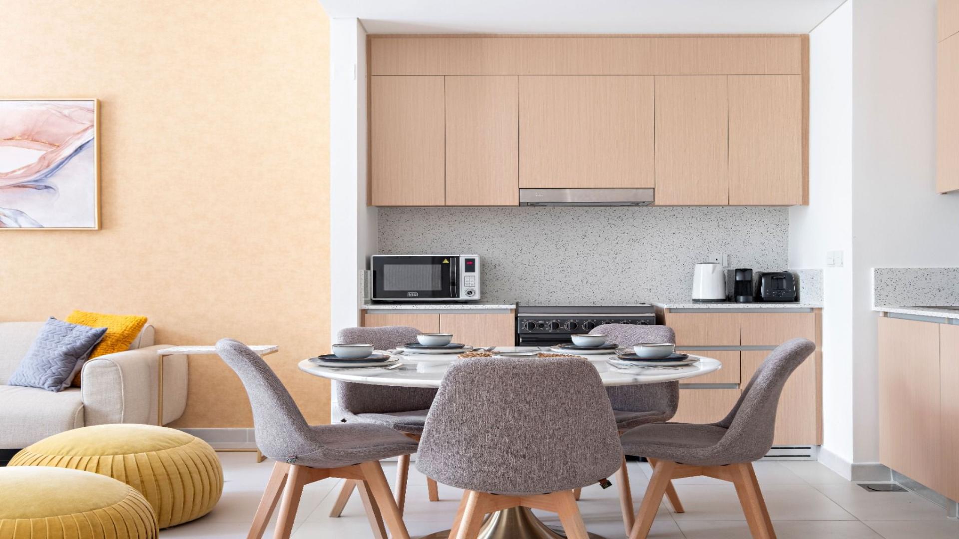 Modern living room in Dubai Creek Harbour apartment, featuring stylish decor and natural light